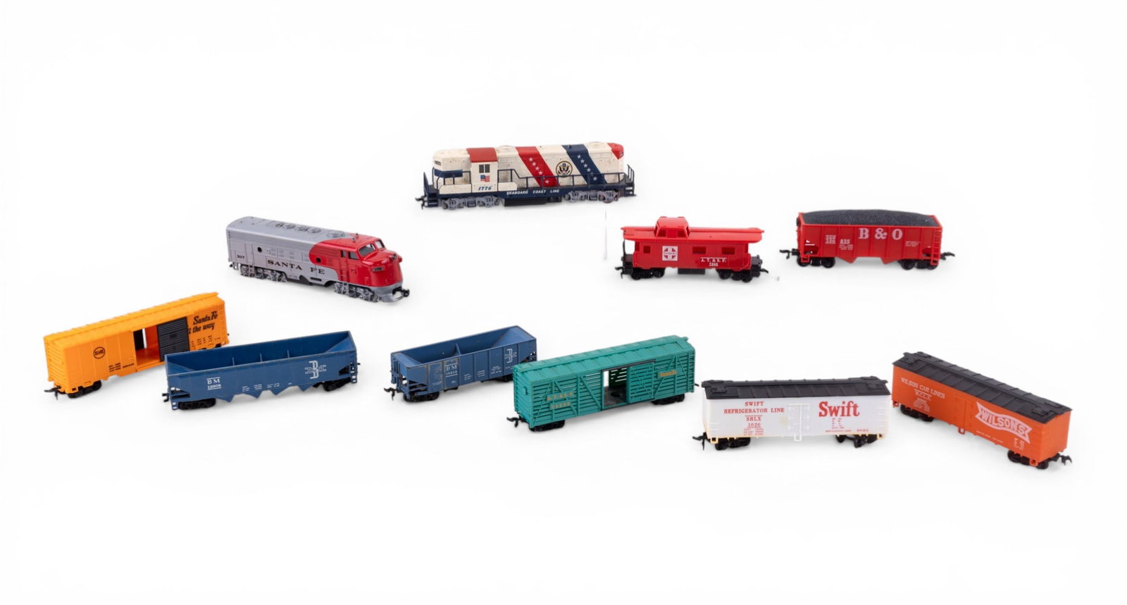 HO Gauge Locomotives and Cars: A collection of HO gauge locomotives and cars including a Bachmann Santa Fe 307 locomotive, an AHM Spirit of 76 Bicentennial locomotive, Boston and Maine hopper car, TYCO Boston and Maine BM 12608 hop