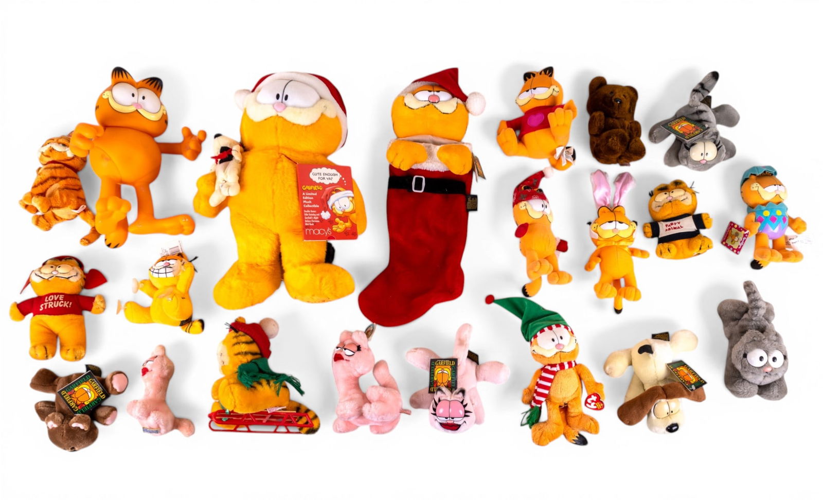 Vintage Christmas and Other Garfield Plush Toys: A large collection of vintage Christmas and other themed Garfield plush toys including a 25 year edition Macy's Garfield and Odie plush, a Garfield Christmas stocking, and various other plush.