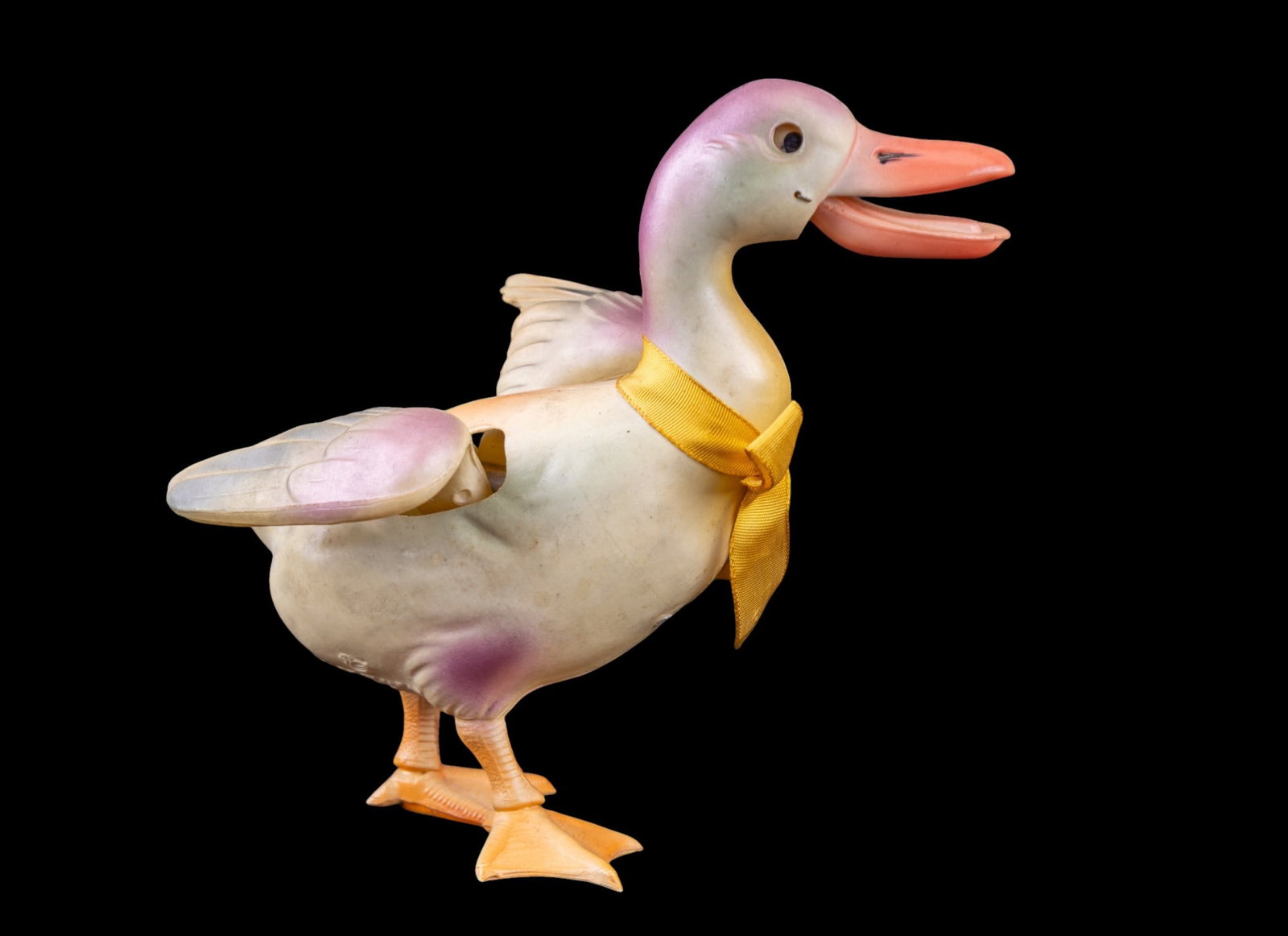 Kinetic Vintage Duck Toy with Moving Parts: Kinetic vintage duck toy featuring movable components, including a vibrant orange beak and detailed wings. Painted with pink, yellow, and cream tones, the toy includes a yellow ribbon tied around its
