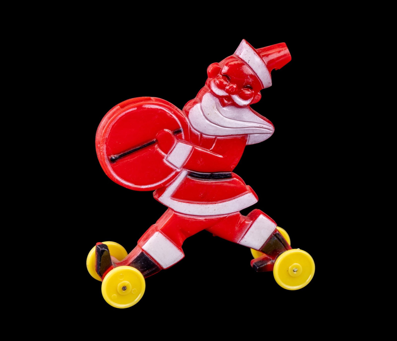 Rosbro Plastic Skiing Santa Whistle Toy: Rosbro plastic figurine featuring Santa Claus in a skiing pose. Santa is molded in red plastic, accentuated with white and black painted details, and includes yellow wheels.
