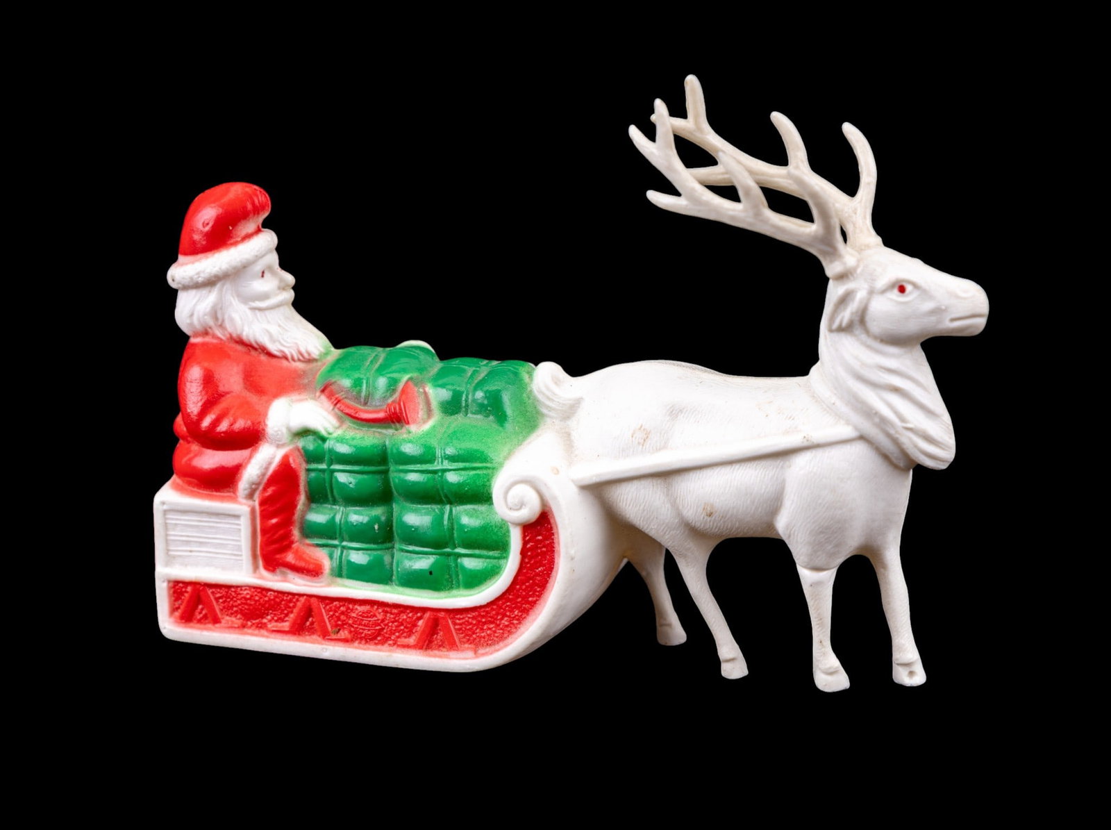 Irwin Viscaloid Santa Claus Sleigh with Reindeer: Vintage Irwin Viscaloid plastic figurine featuring Santa Claus in a sleigh loaded with toys, led by a single reindeer. Made of molded plastic in red, white, and green. The figure depicts Santa with a