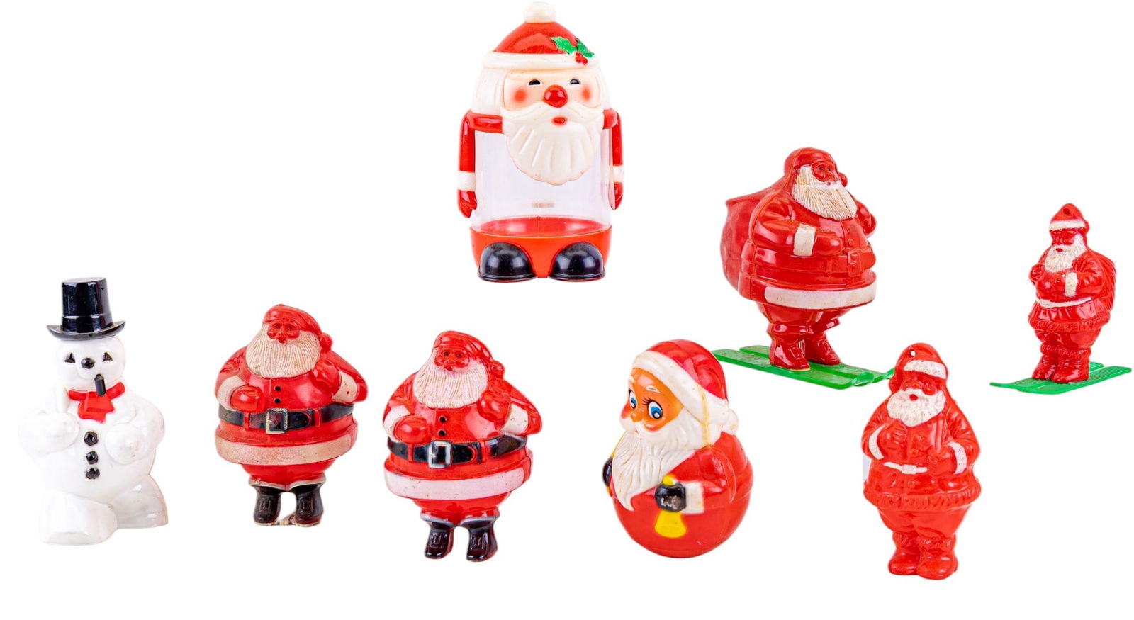 Celluloid Santa Candy Containers: Celluloid Santa candy containers, featuring hand-painted designs in red, white, and other festive colors. Includes various styles and sizes, some with markings, such as Kiddie Products Inc. NEW BUYERS