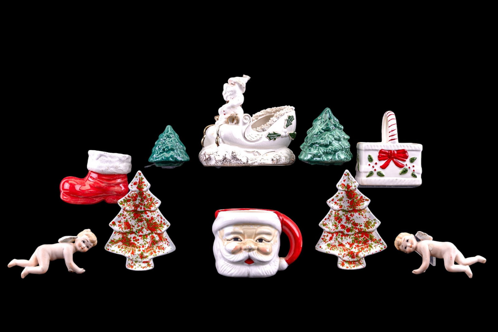 Porcelain Cherubs and Assorted S & P: Porcelain cherubs, some items marked Lefton, and various salt and pepper shakers. Includes Christmas-themed items like tree-shaped shakers, a Santa figure in a sleigh, and additional holiday d?cor.