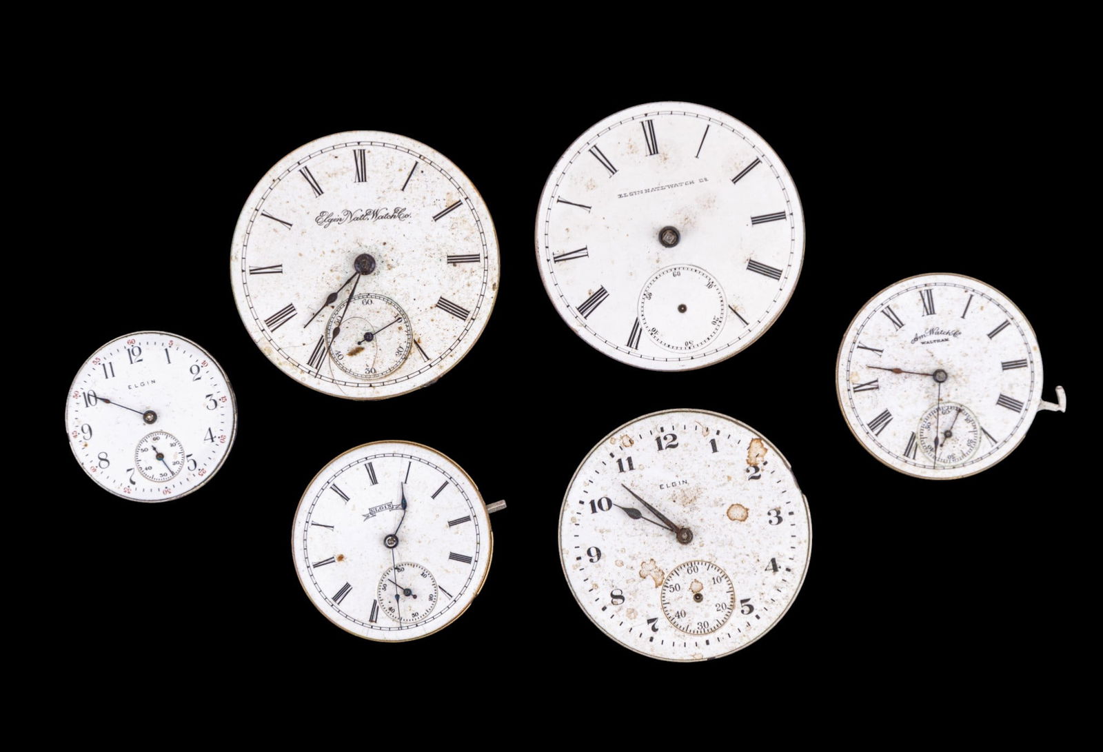 Elgin and Waltham Pocket Watch Movements: Five Elgin pocket watch movements and one Waltham movements, featuring porcelain dials. Dial diam range from 1.125" to 1.75". Names and style/edition numbers as seen in photos.