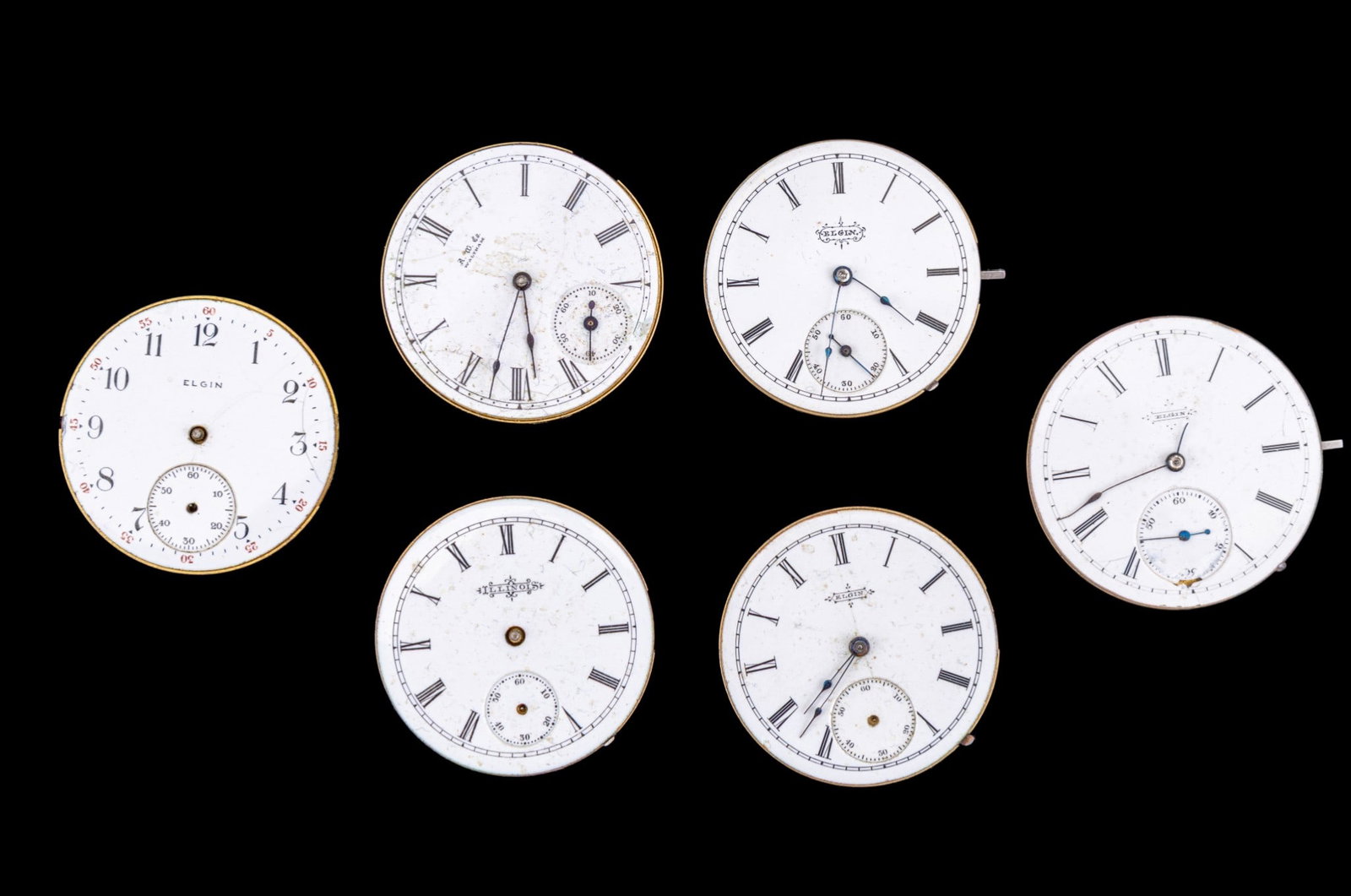 Elgin, Illinois, Waltham Pocket Watch Movements: Four Elgin pocket watch movements, and other movements by Waltham, and Illinois, featuring porcelain dials. Dial diam all measure 1.625". Names and style/edition numbers as seen in photos.