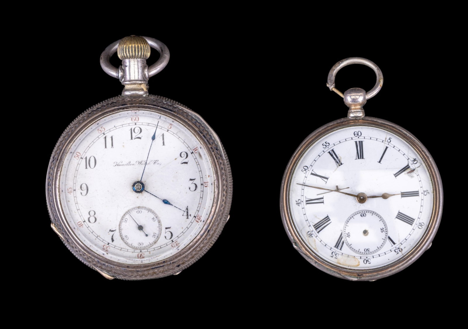 Hamilton and Other Pocket Watches: A Hamilton pocket watch #32598 in a coin silver etched antique case # 1541009 and an unmarked movement in a silver plate case #24468. Both feature porcelain dials, note cracks.