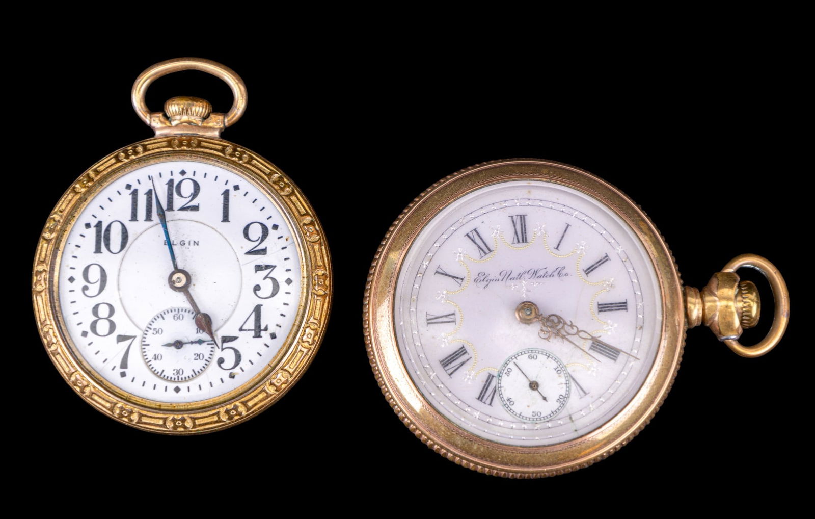 Elgin Pocket Watches: An Elgin pocket watch in a gold tone Supreme case and an Elgin pocket watch with ornate porcelain dial, 1.75" diam, and a floral etched gold tone Essex Columbia 20 year gold plated case. Names and sty