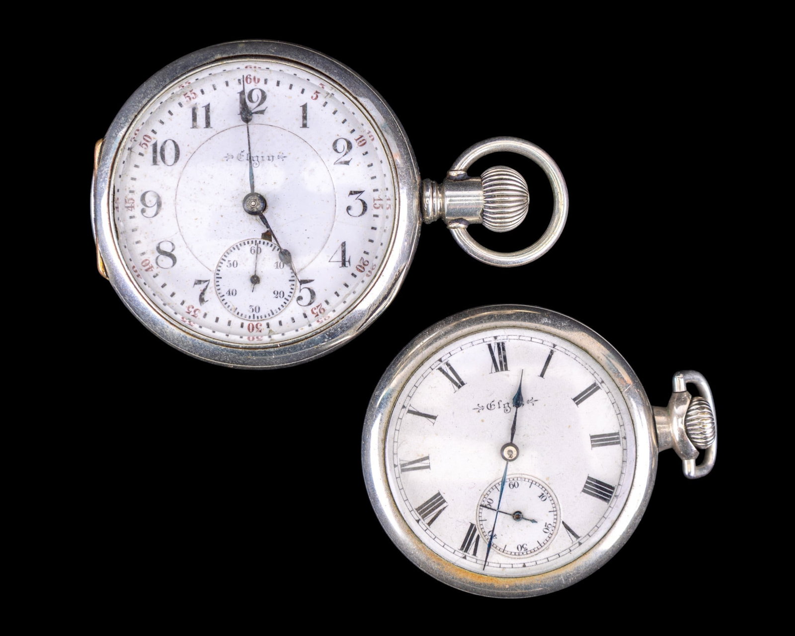 Elgin Pocket Watches: Elgin 15 jewel pocket watch in a Keystone silveroid twist off case and an Elgin 17 jewel pocket watch in a Keystone silveroid huntsman case, both with porcelain dials, largest diam measures 1.875". Na