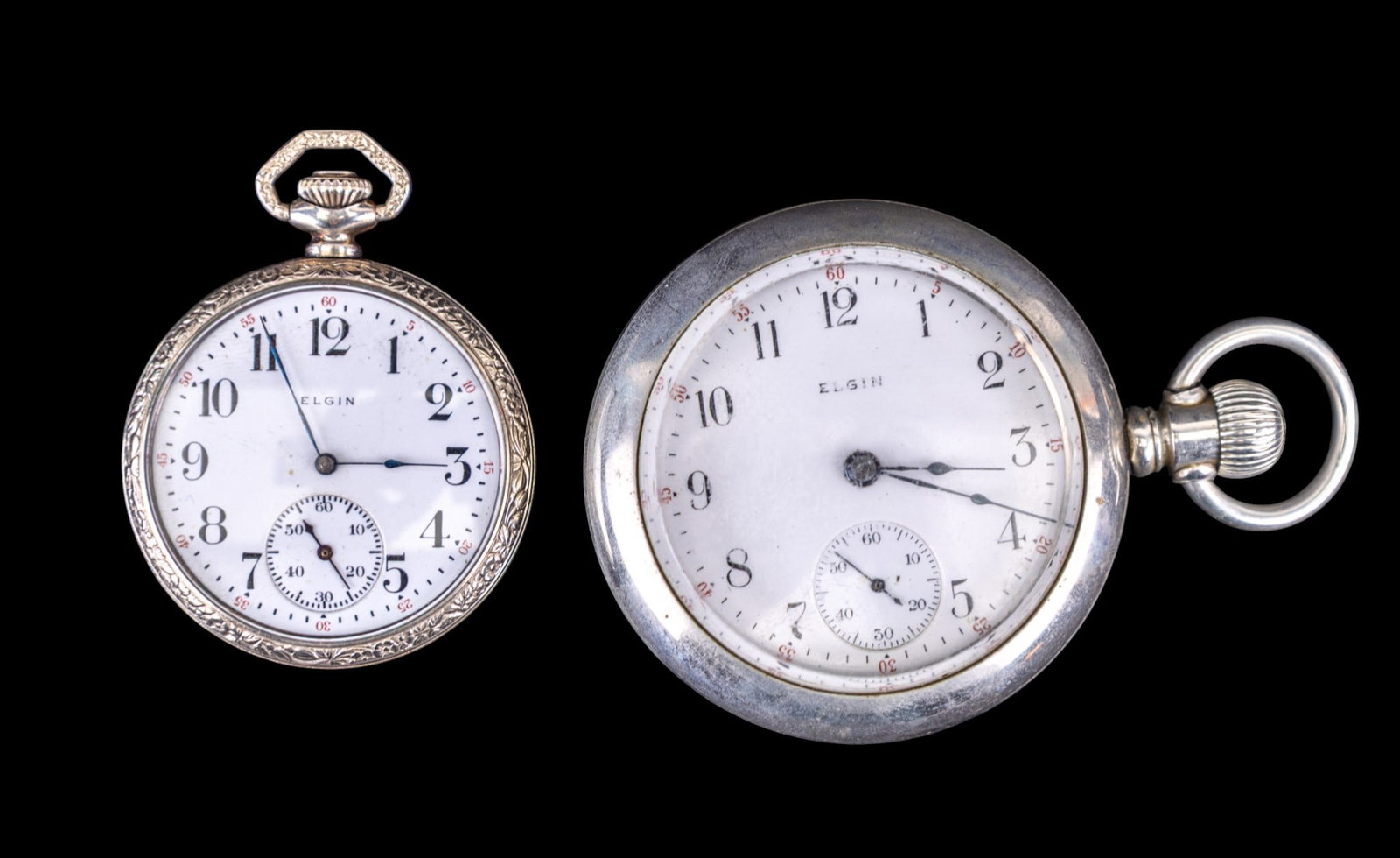 Elgin Pocket Watches: An Elgin pocket watch in a Philadelphia silverode twist off case with a 1.875" diam porcelain dial, note etched design of flowers and manor house is slightly visible, and an Elgin pocket watch in a Vi