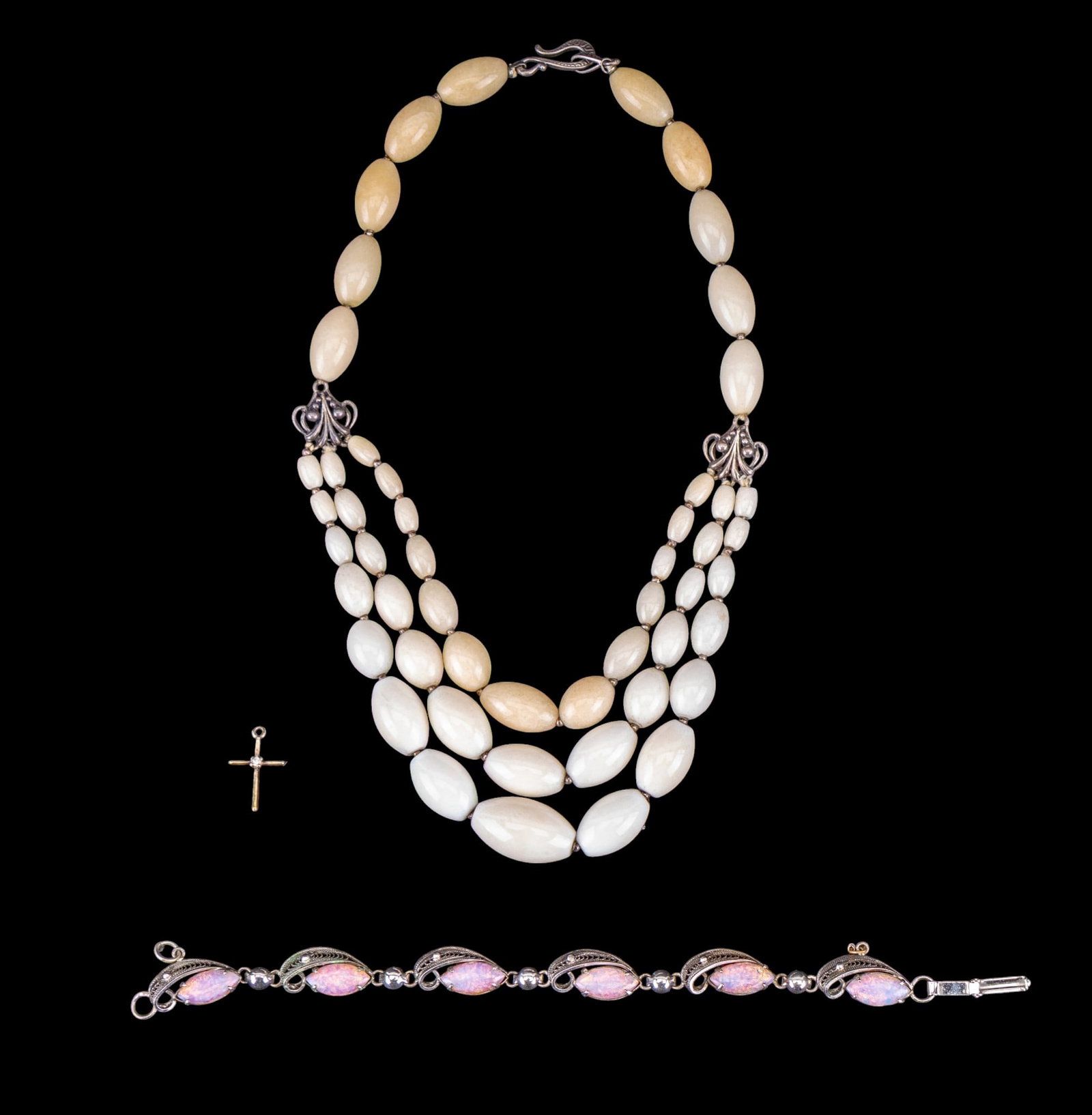 Vintage Sterling Jewelry: A vintage sterling silver filigree bracelet featuring marquis cabochon Mexican opals by Sorrento, a gold tone sterling Cross pendant with cut stone center, and a vintage multi-strand calcite bead neck