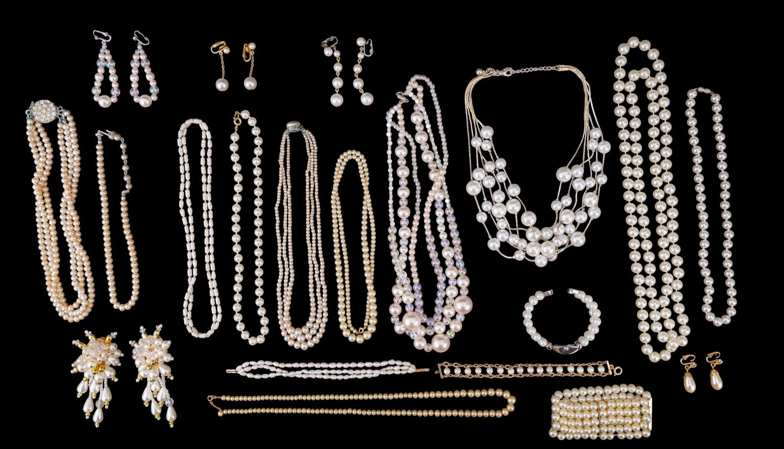 Vintage Faux Pearl Jewelry: A collection of vintage faux pearl jewelry including clip on and screw back earrings, mid century graduated and multi strand graduated necklaces, costume strands of faux pearls, and more.