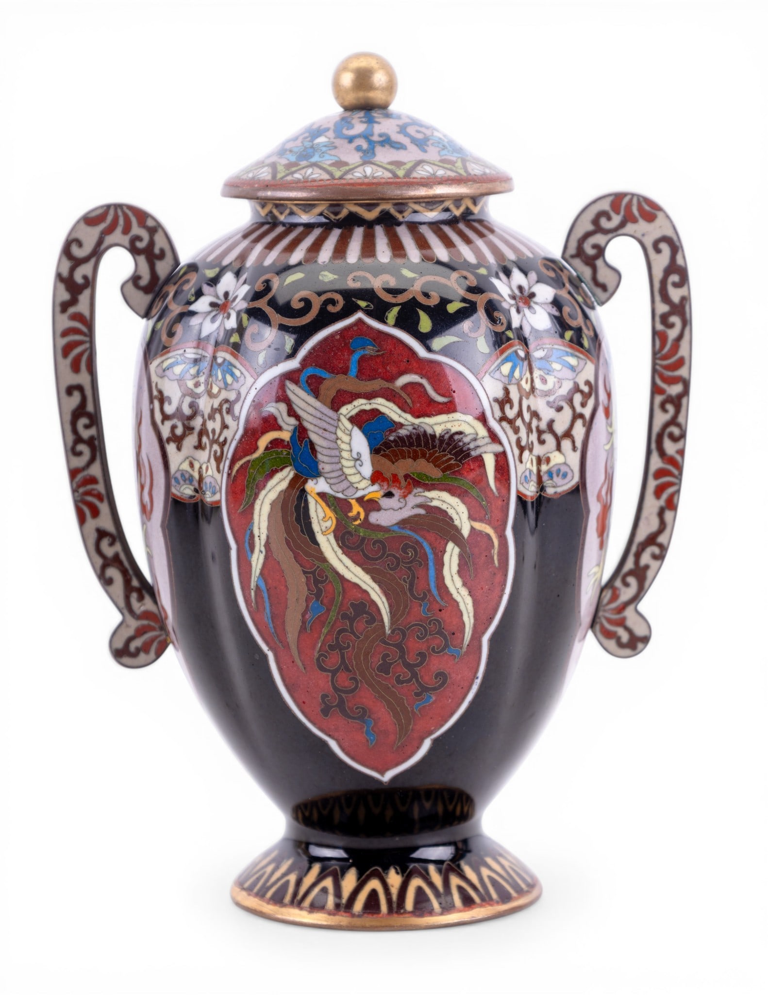 Japanese Cloisonne Urn w/ Phoenix Motif: Japanese cloisonne enamel urn decorated with phoenix motif and floral designs, twin scroll handles and domed lid, polychrome enamel on dark ground. Measures approx. 5" W x 7.5" Tall.