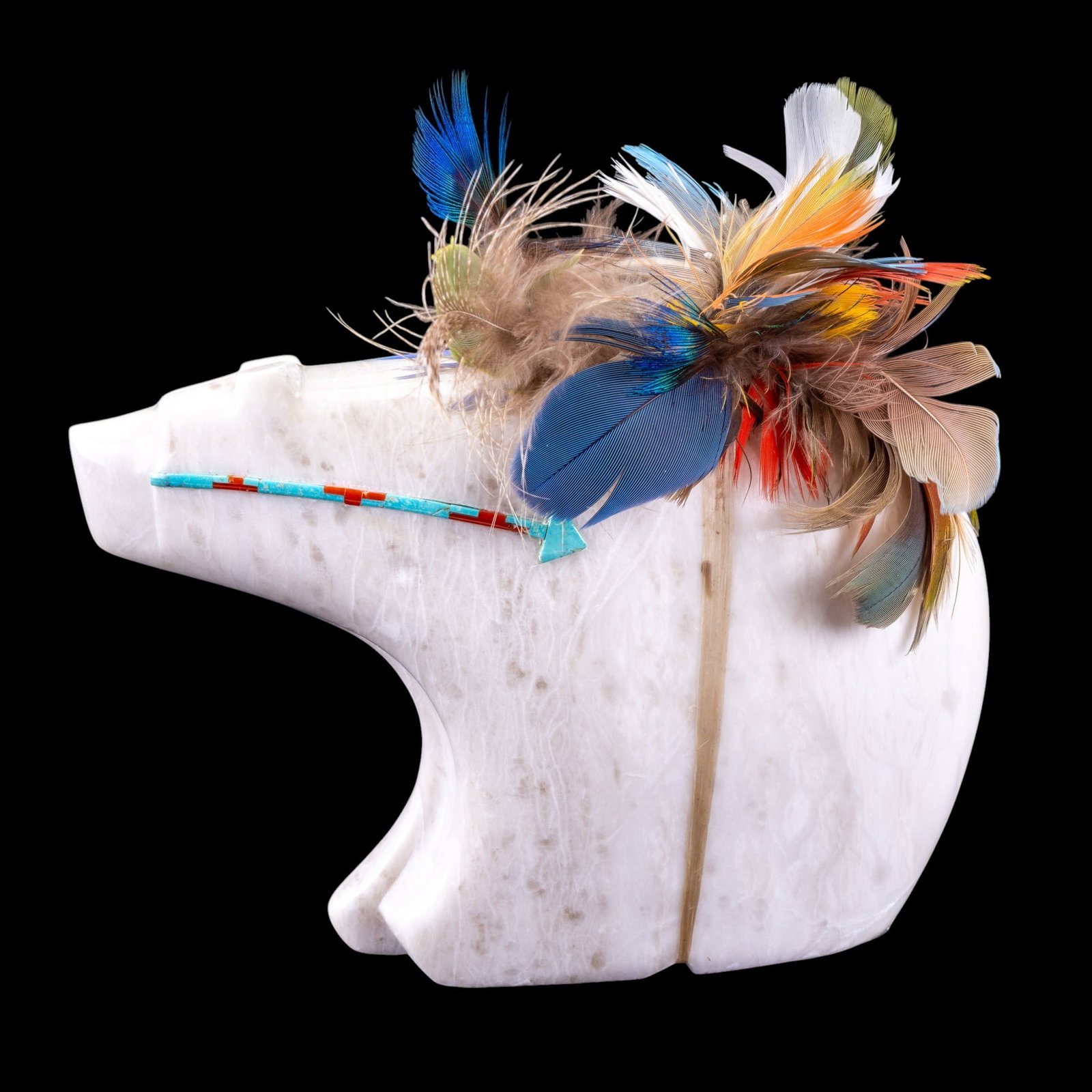 Native Style Alabaster Bear Figurine: A Native style carved and polished alabaster bear figurine featuring turquoise and coral accents and feather decorations, measures approx. 6.5" W x 5" H.
