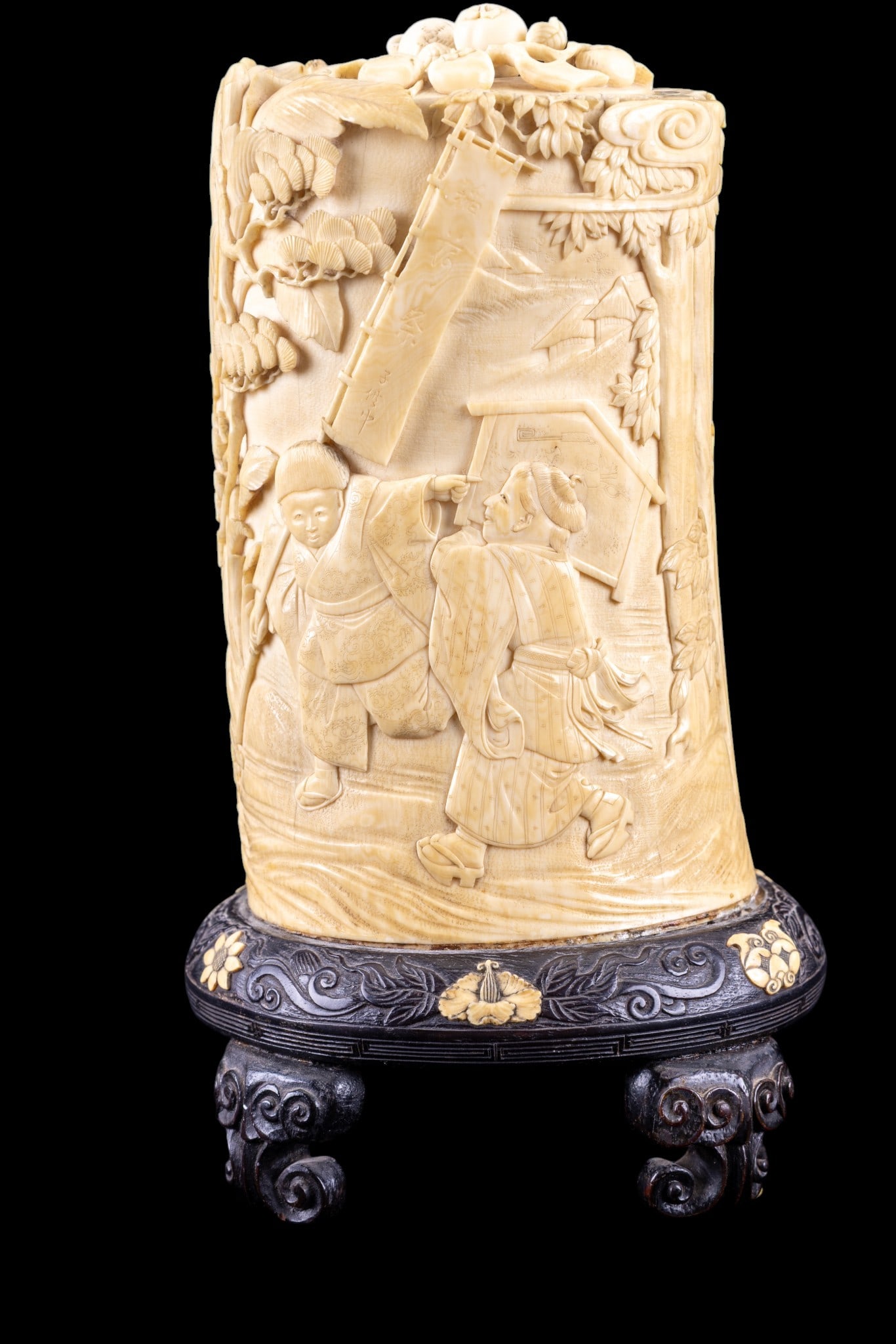 Japanese Carved Lidded Figural Vessel: Japanese carved natural material cylindrical lidded container, intricately worked in high relief with figural scenes including robed figures in landscape settings. Lid features berry and twig motifs.