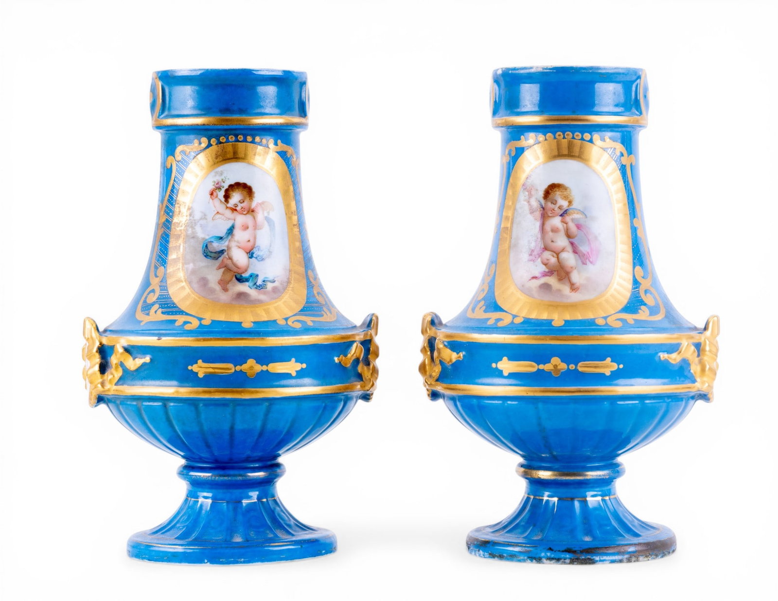 19th C French Sevres Porcelain Vases (2): A pair of 19th C hand painted French Sevres porcelain vases depicting floral scenes and cherubs, marked on the bottom, both measure approx. 8.5" H. Note some loss around the base, vases appear to