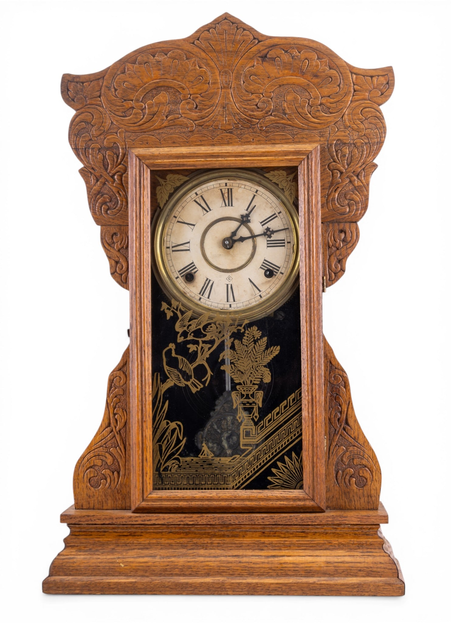Wm. L. Gilbert Carved Parlor Clock: American parlor clock by Wm. L. Gilbert Clock Co., Winsted, Connecticut. Features a richly carved wooden case with foliate crest, original paper dial with Roman numerals, and a spring-driven