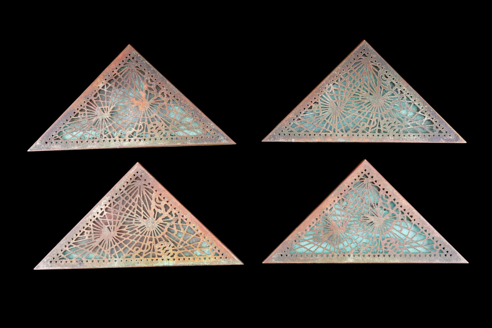 Tiffany Studios New York Desk Calendar Corners: Set of 4 Tiffany Studios New York bronze desk calendar or blotter corners, model number 997, each of triangular form with pierced geometric motifs. Each marked "Tiffany Studios New York 997".