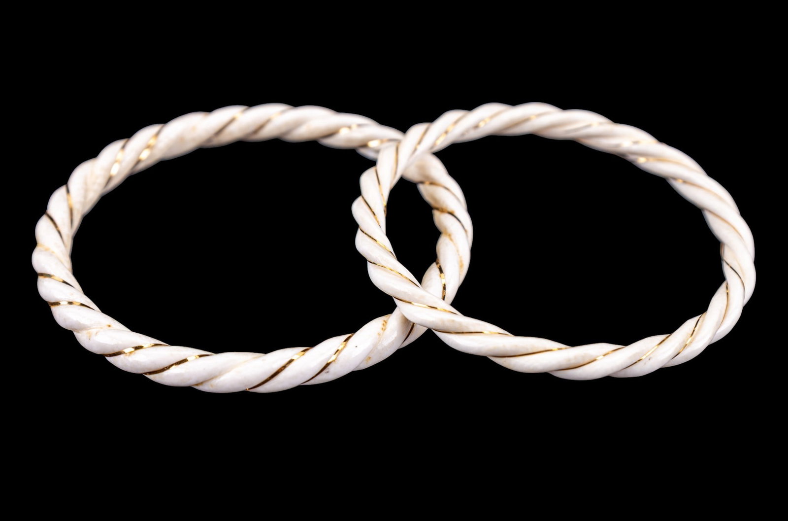 Carved Natural Material Gold Twist Bangles: A pair of braided twist style carved natural material bangle bracelets with gold wire accent, diam. measure approx. 2.325" and 2.5". MUST BE SOLD IN PA ONLY- Item can only be sold to Pennsylvania