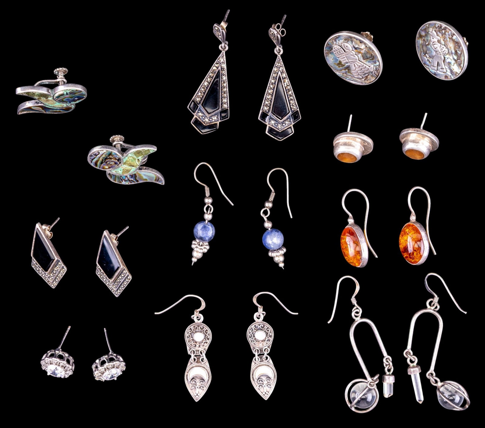 Sterling Silver Earrings (10 prs): A collection of 10 pairs of sterling silver earrings featuring pave marcasite, stone inlay, amber, facet cut stones, abalone inlay and others. Total weight is approx. 67g.