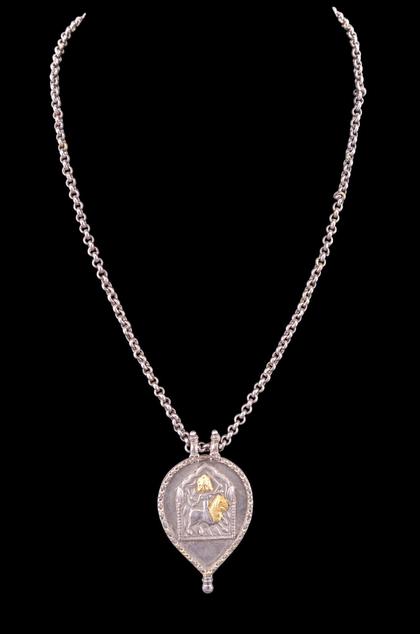 Indian Kavach Protective Pendant Necklace: An Indian repousse silver and gold leaf Kavach protective pendant necklace depicting the Goddess Durga on a lion. Measures approx. 14" L total, weighs approx. 50g.