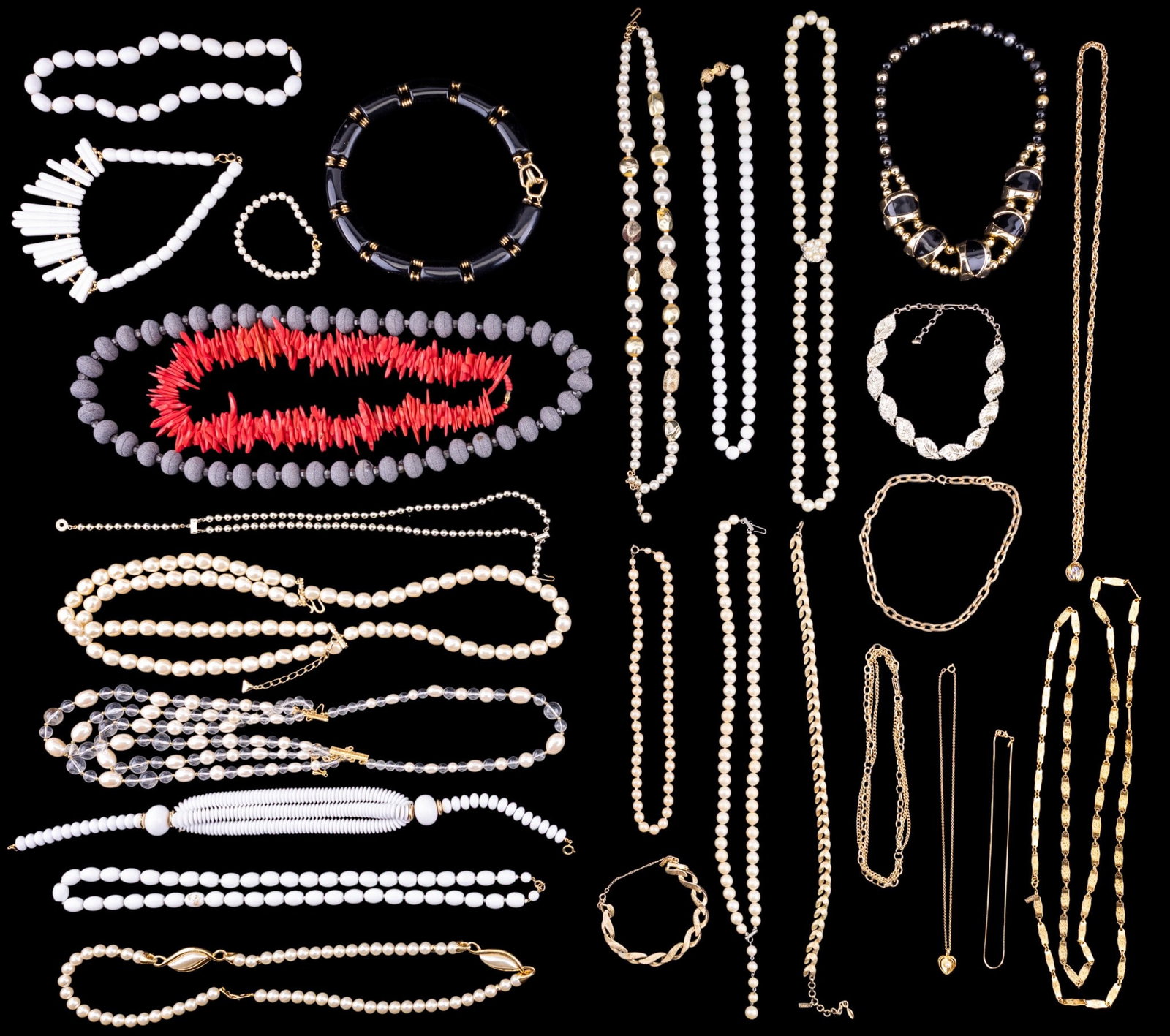 Eclectic Necklaces: A variety of unique necklaces, including one in pink carved wood and several pearl styles.