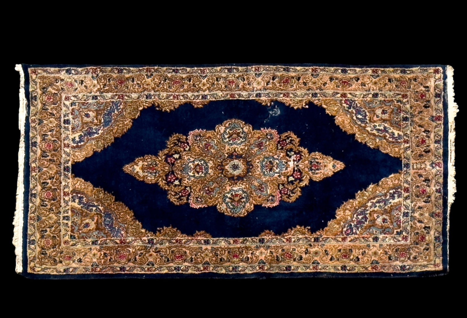 Persian Kirman Rug: Persian Kirman area rug with a blue field. Some loss as seen in photography. Measures approx. 2'11" x 5'3".