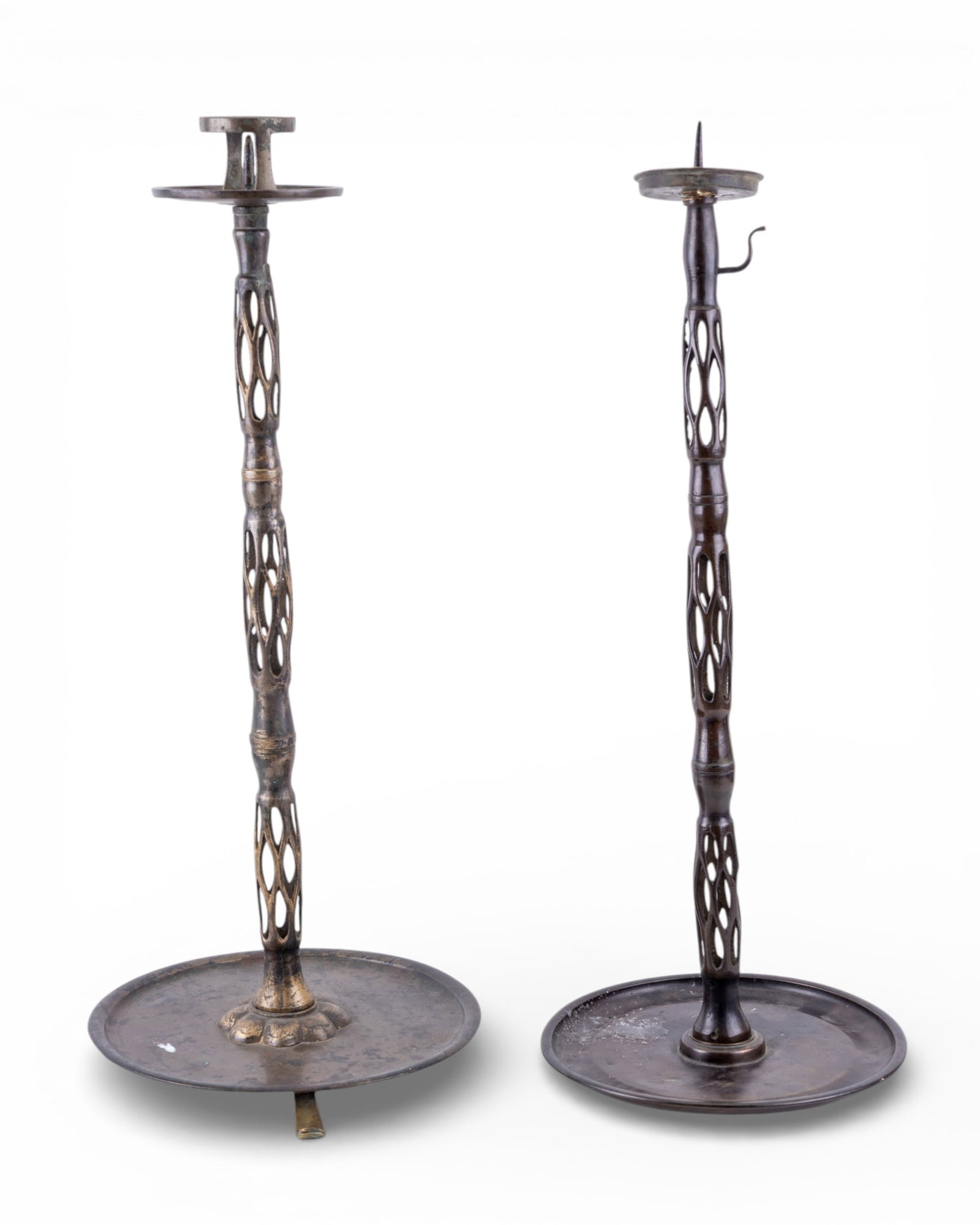 Pair 19C Korean Candlesticks w/ Lattice Stem: Assembled pair of 19th Century Korean brass candlesticks / candle holders with tall slender stems featuring pierced / lattice like openwork design. Taller measures approx. 21.5" H.
