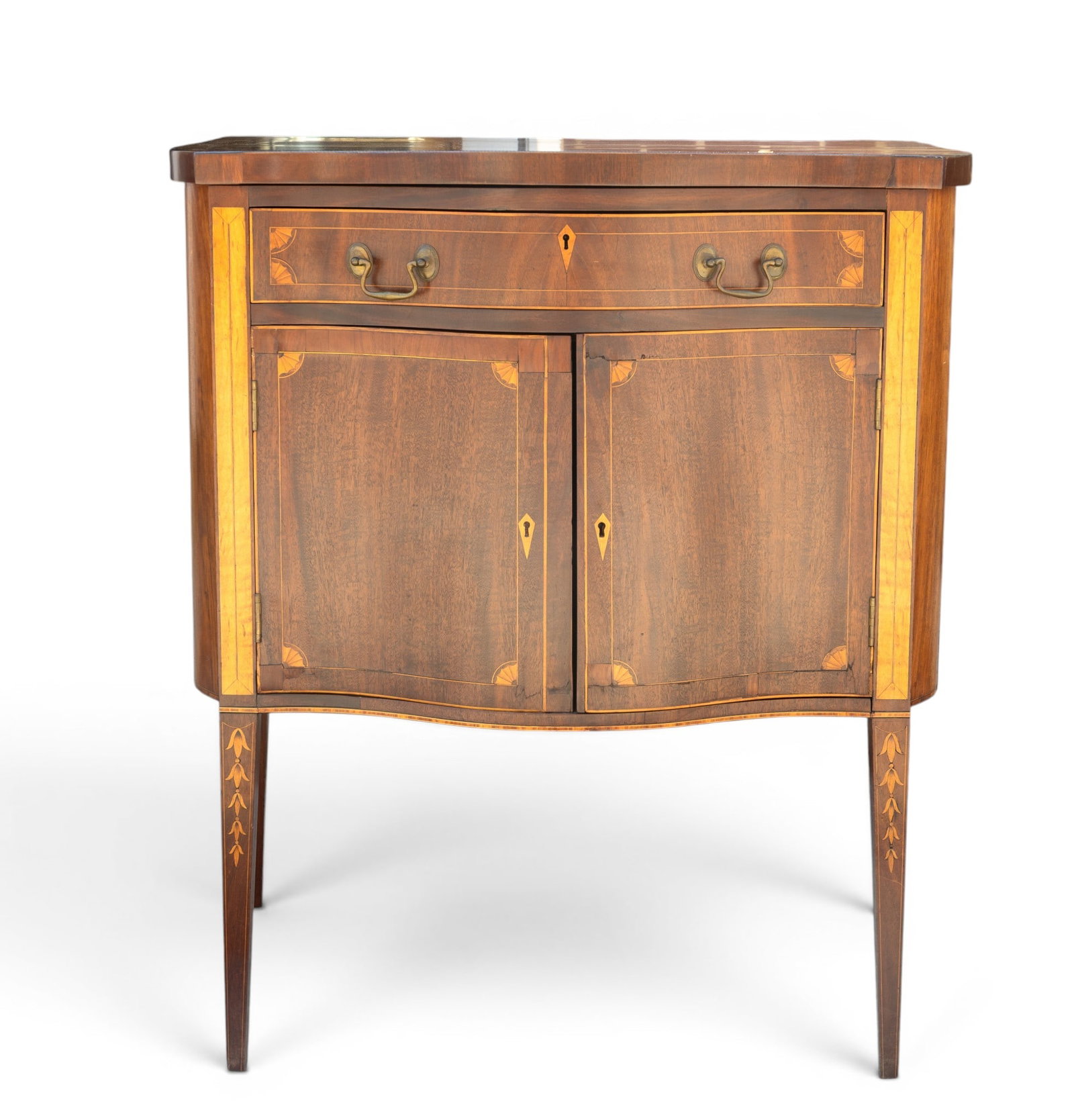 Serpentine Inlaid Cabinet / Sideboard: Wooden cabinet featuring a serpentine front design. Measures 38.5? H x 33.5? W x 24.5? D. The piece includes one drawer and two lower doors with ornate inlay details and brass hardware. Tapered legs