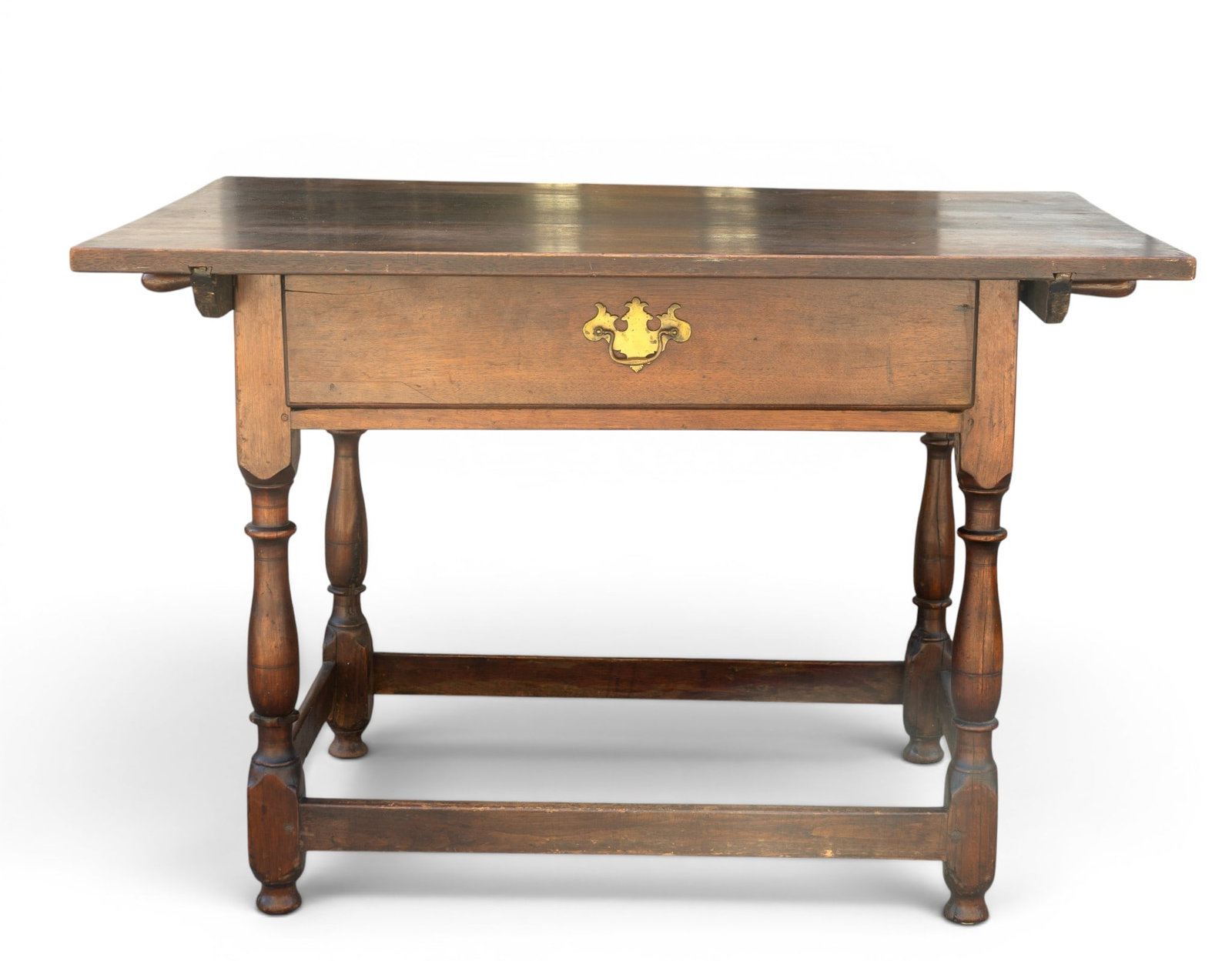 Tavern Table with Detachable Top: Rectangular wooden table featuring turned legs and an H-shaped stretcher base for structural support. Equipped with a single drawer with brass pull hardware. The tabletop is removable, allowing for