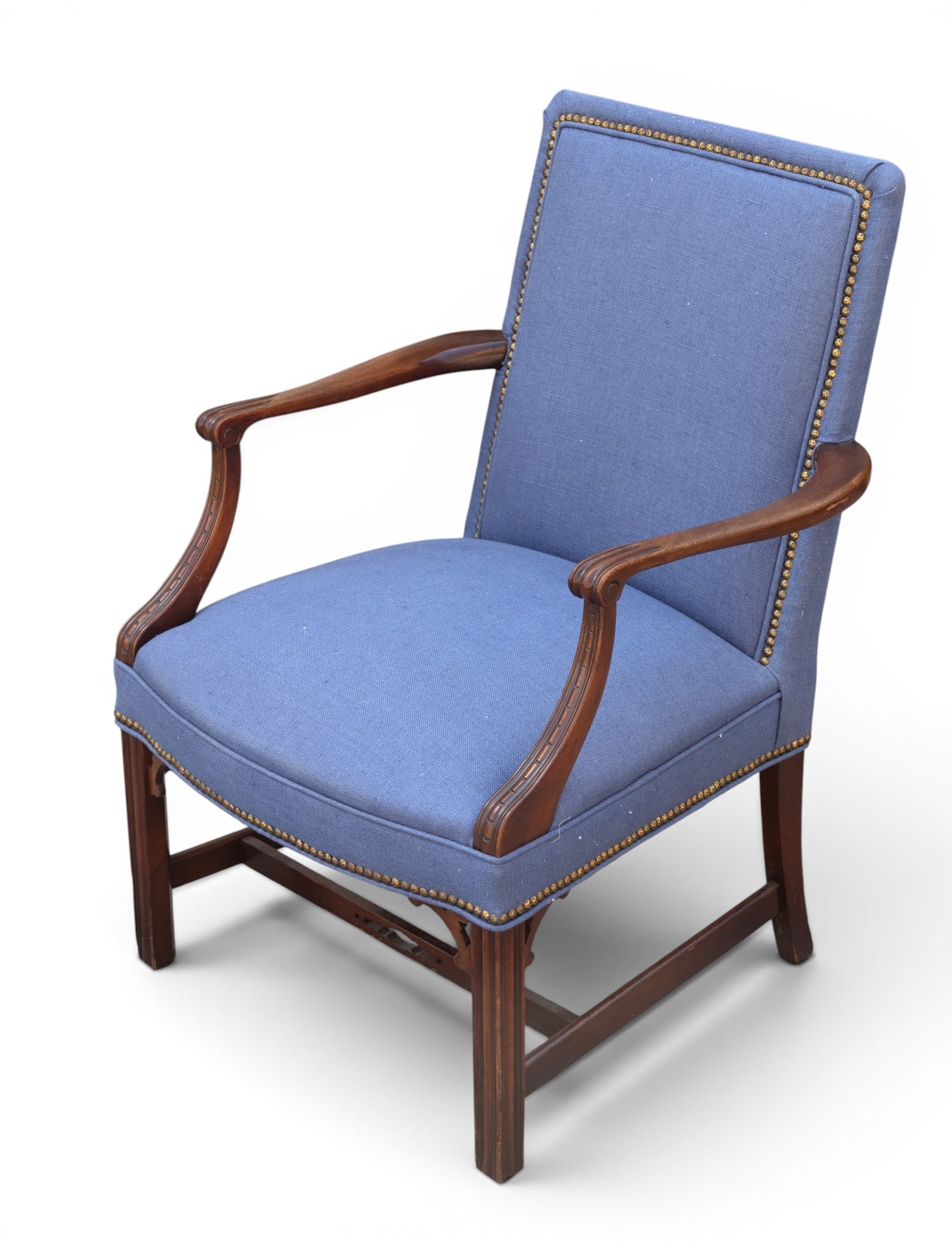 Classic Armchair with Blue Upholstery: Armchair featuring a wooden frame with curved armrests and legs. Almost a Martha Washington style chair. The backrest and seat are upholstered in blue fabric with a textured pattern. Brass nail head