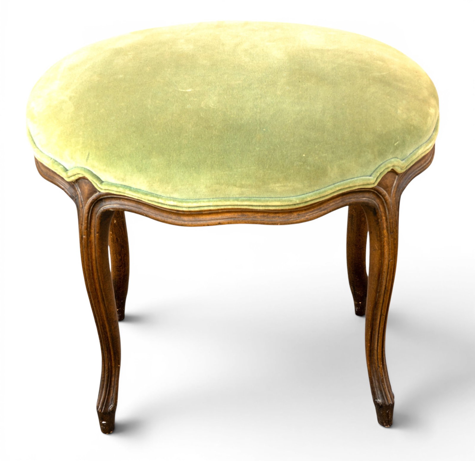 Antique French Velvet Footstool: An antique French mahogany footstool featuring a fine light green velvet upholstery. Measures approx. 22" W x 16" D x 18" H. Pick up must be completed within two weeks from auction, or storage fees wi