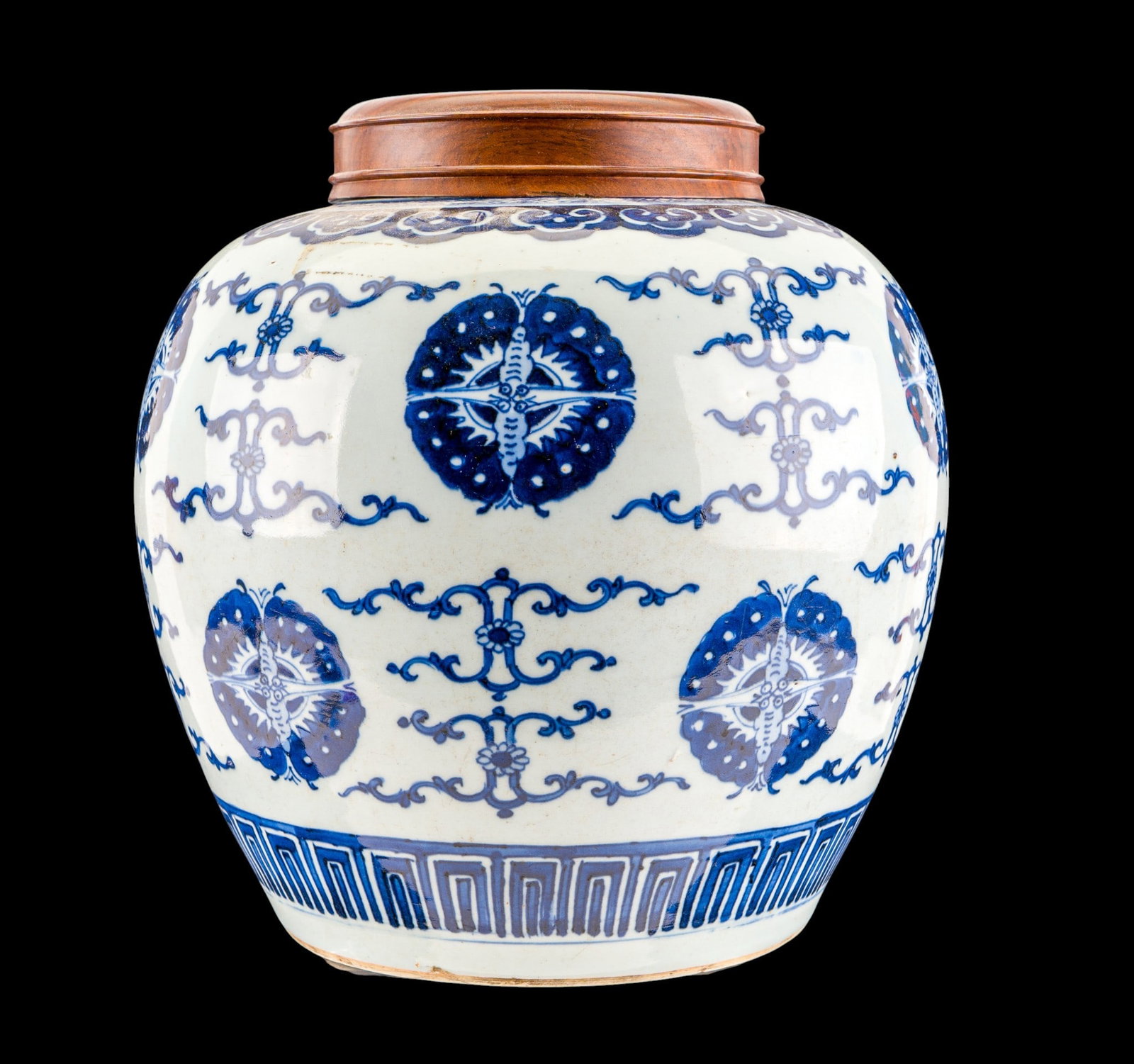 Chinese Blue and White Ginger Jar: Chinese blue and white porcelain rounded ginger jar with short neck, decorated with repeating foliate and emblematic motifs above a geometric border. Underside with unglazed foot rim. Chip present on 