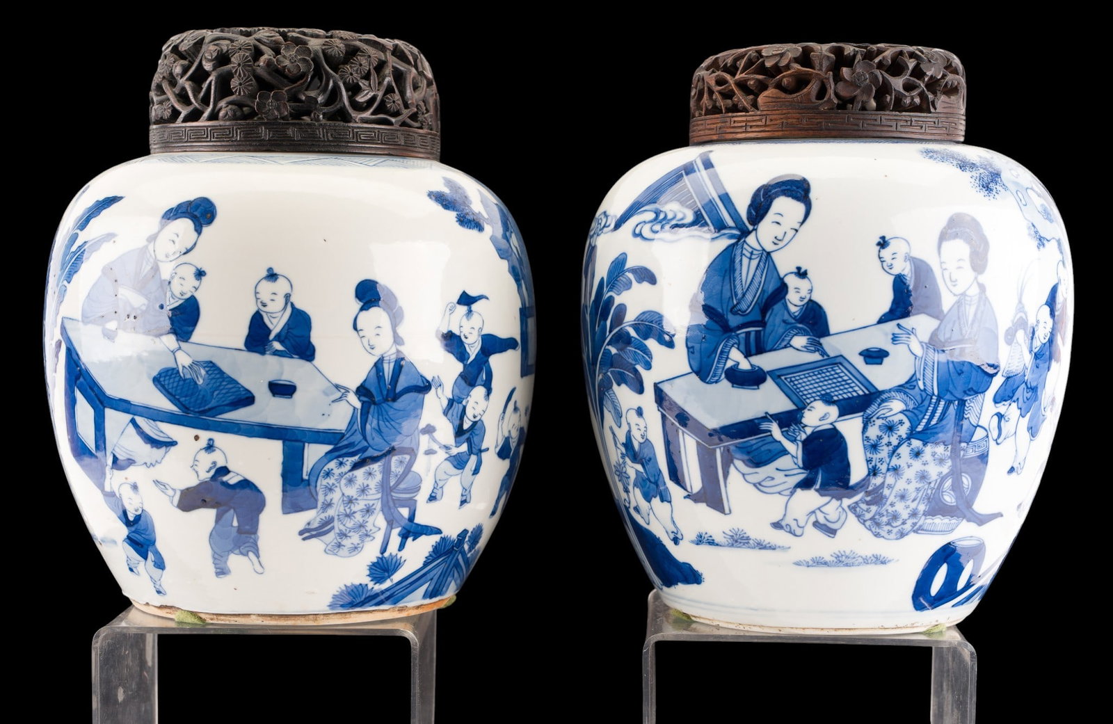 Pair of Chinese Blue & White Ginger Jars: Companion pair of Chinese blue and white porcelain ginger jars, each decorated with continuous figural scenes depicting women and children in garden and interior settings. Each jar is accompanied by l
