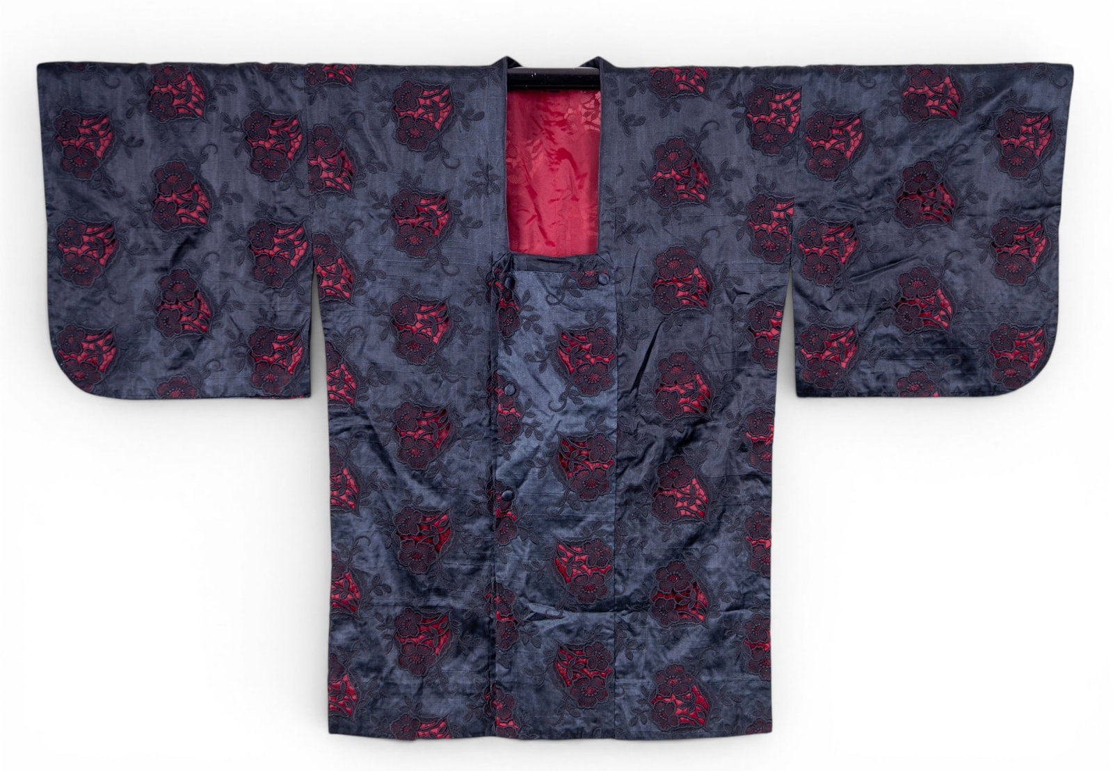 Haori Black & Red Silk Jacket w/ Floral Embell.: A Japanese black and red silk jacket with reticulated floral embellishments showing red silk underneath. Item measures approx. 33" hem to collar and 52" cuff to cuff.