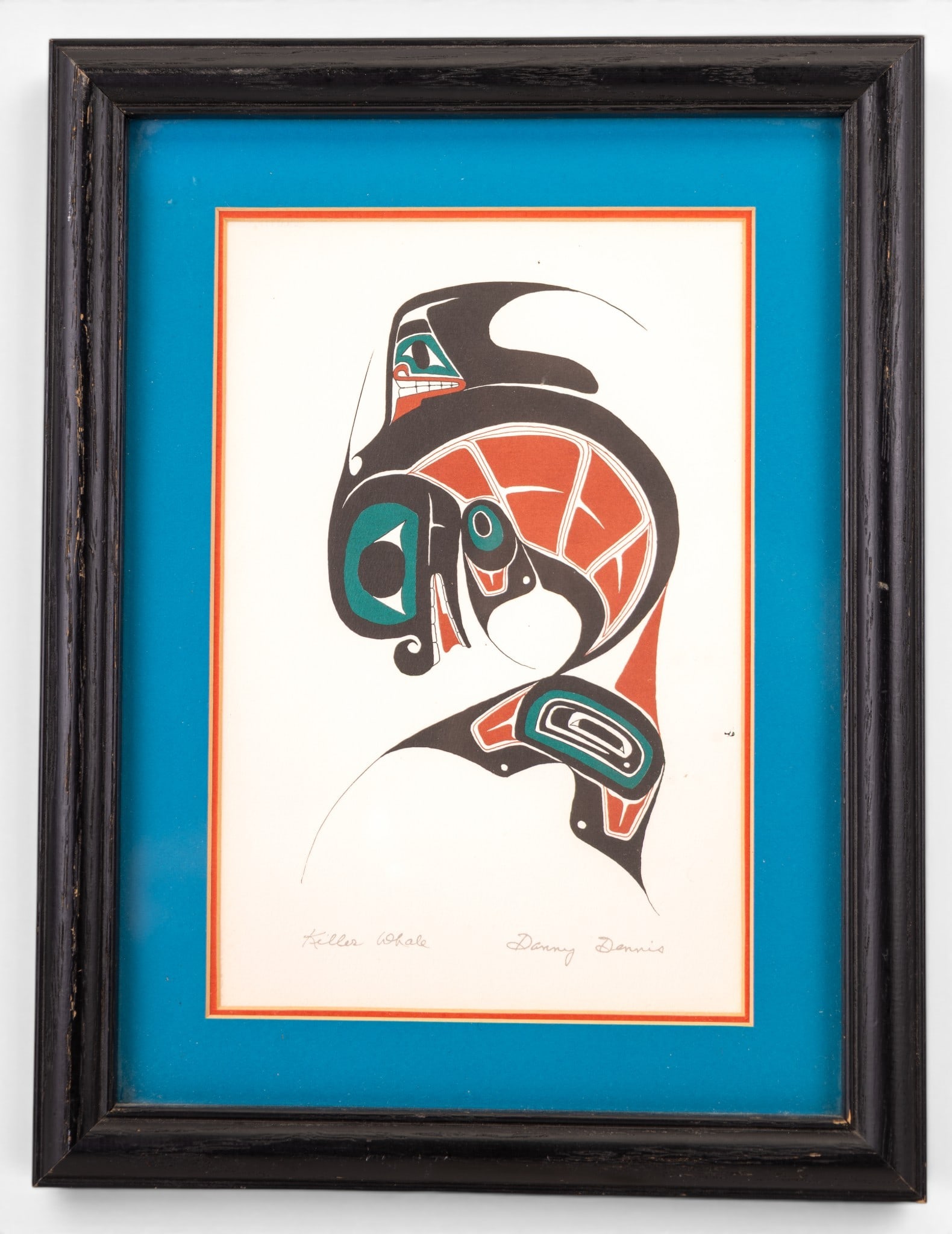 'Killer Whale' After Danny Dennis Print: A framed print depicting a Haida orca titled 'Killer Whale' after Danny Dennis (Canadian 1951-2012) featuring facsimile title and signature. Measures approx. 10" W x 13" H.