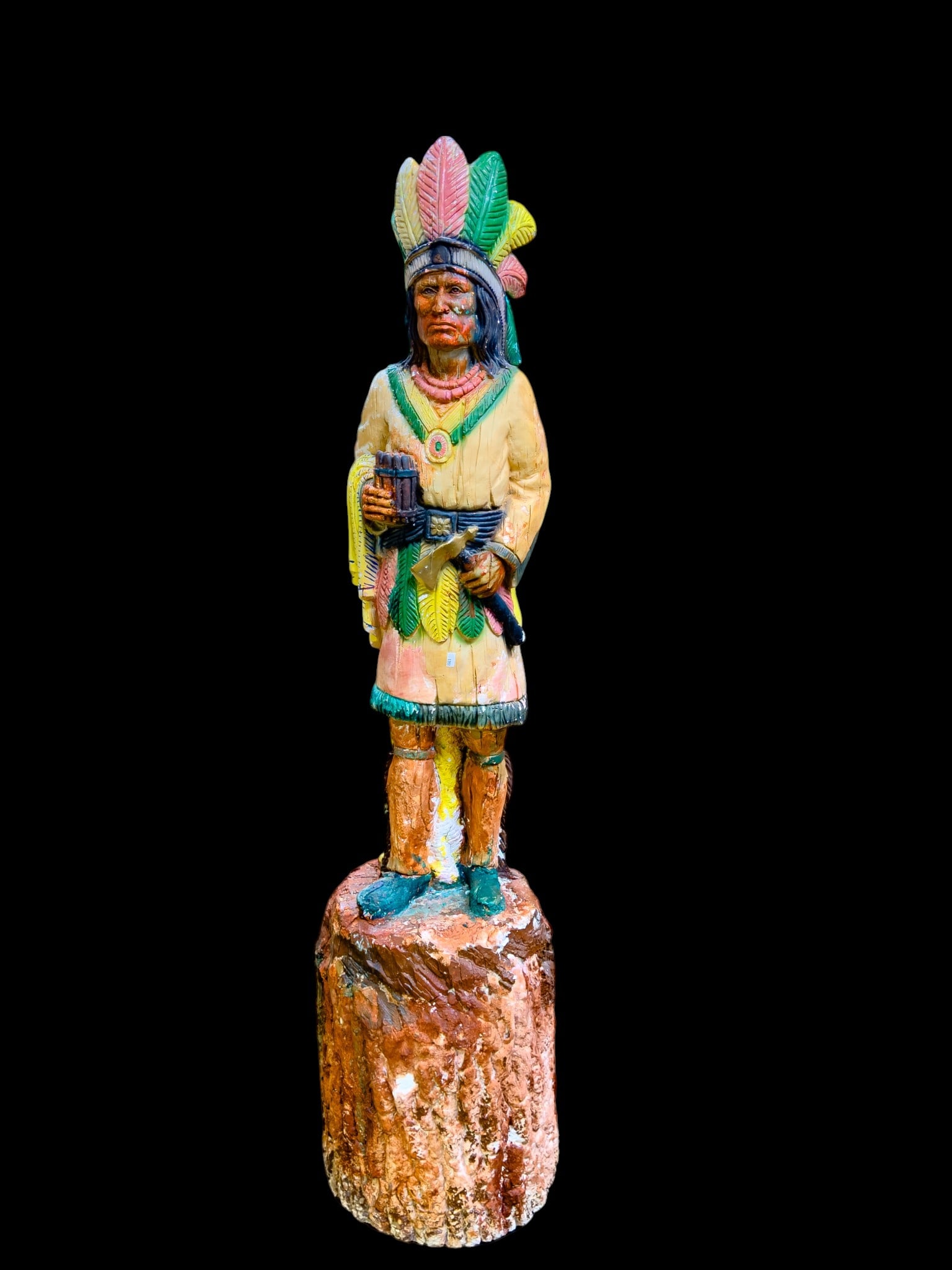 Vintage Plaster Cigar Store Indian Statue: A vintage painted cast plaster 'Cigar Store Indian' depicting a Native Chief with a hand full of cigars. Note loss to painted finish. Measures approx. 56" H and weighs approx. 90lbs. Special