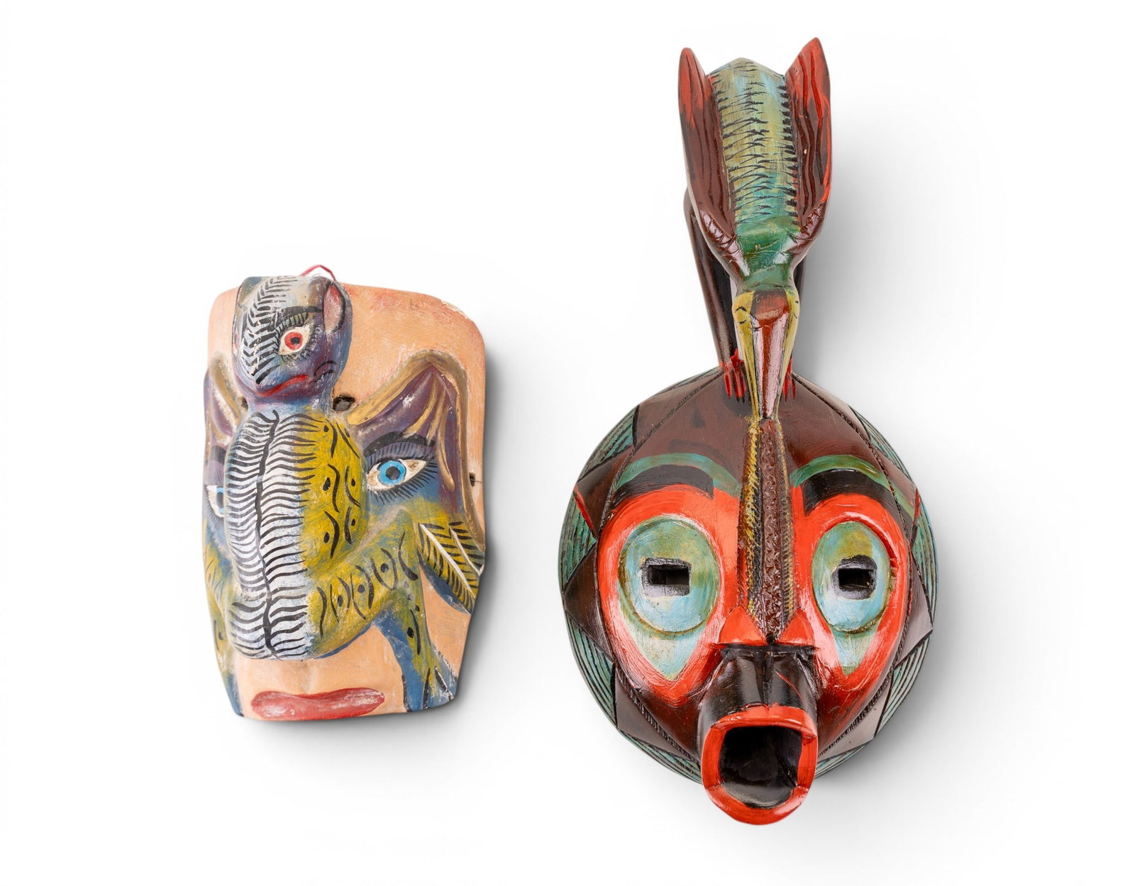 Aztec Nahua Guatemala Carved Wood Masks: Two hand carved and painted Aztec masks including a colorful Nahua Guerrero mask featuring a bat motif, (approx. 7" W x 5" D x 10" H), and a Guatemalan Aztec ceremonial mask featuring a Quetzal bird