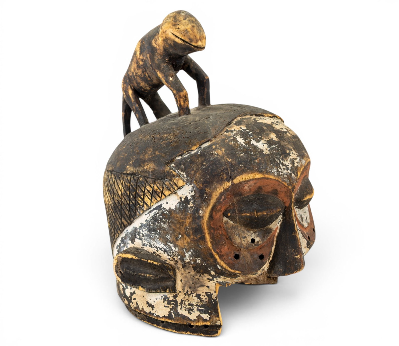 African Suku Carved Wood Helmet Mask: An early hand carved and painted African helmet mask of the Suku people. Note some loss and wear due to age. Measures approx. 14" H x 10" D x 11" W.