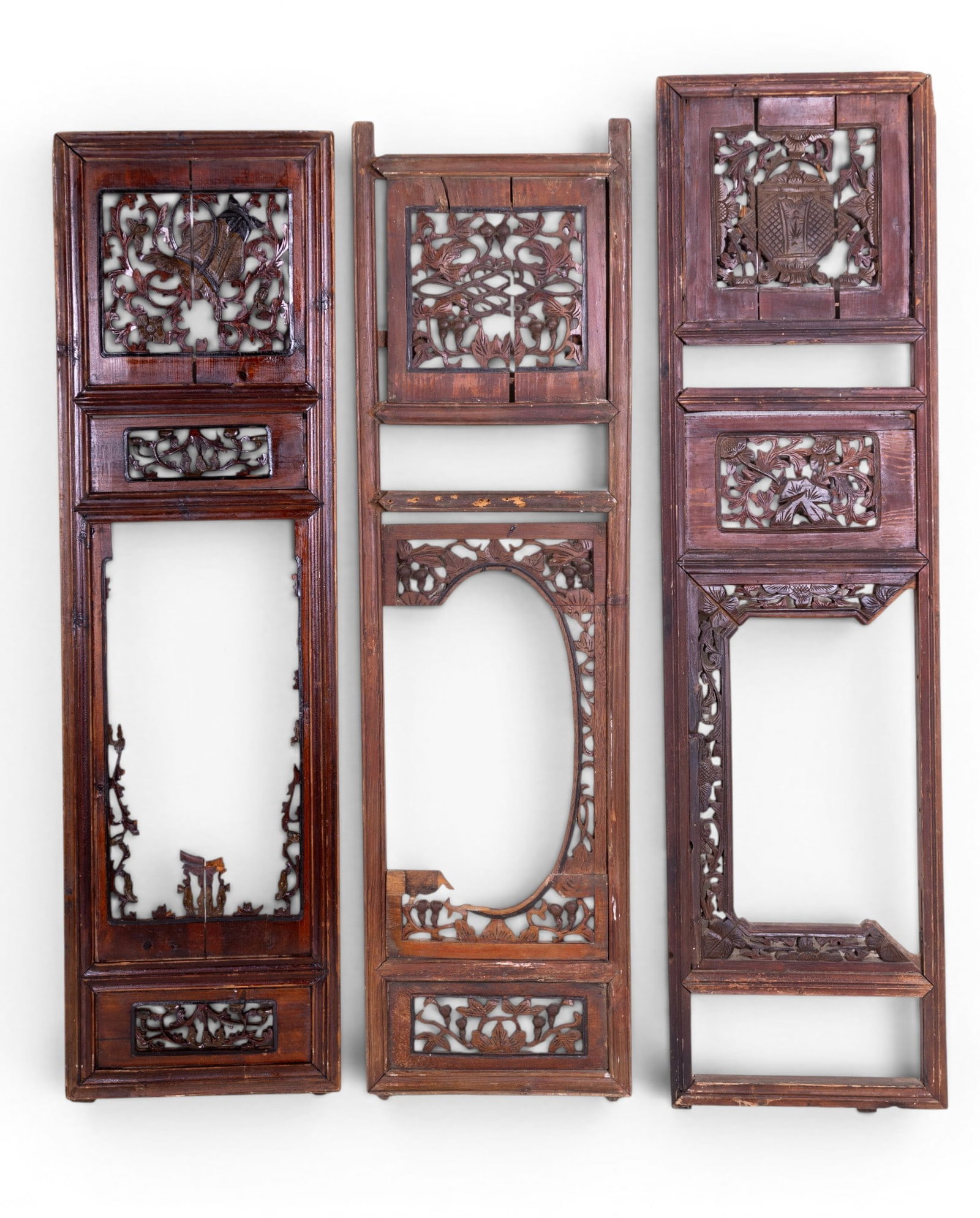 Antique Chinese Carved Wood Window Shutters (3): A collection of three antique Chinese carved and reticulated wood window shutters. Note some loss and wear due to age and use. Largest panel measures approx. 13.5" W x 51.5" H.