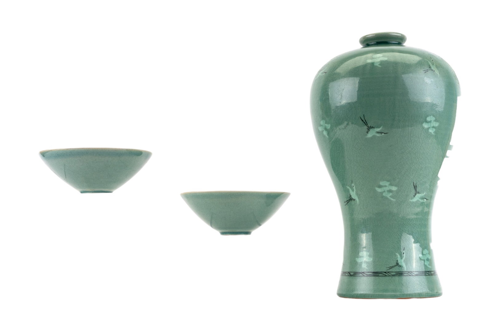 Korean Celadon Maebyeong Vase and Two Bowls: A vintage Korean crazed celadon Maebyeong vase depicting cranes with two matching tea bowls. Vase measures approx. 13" H.