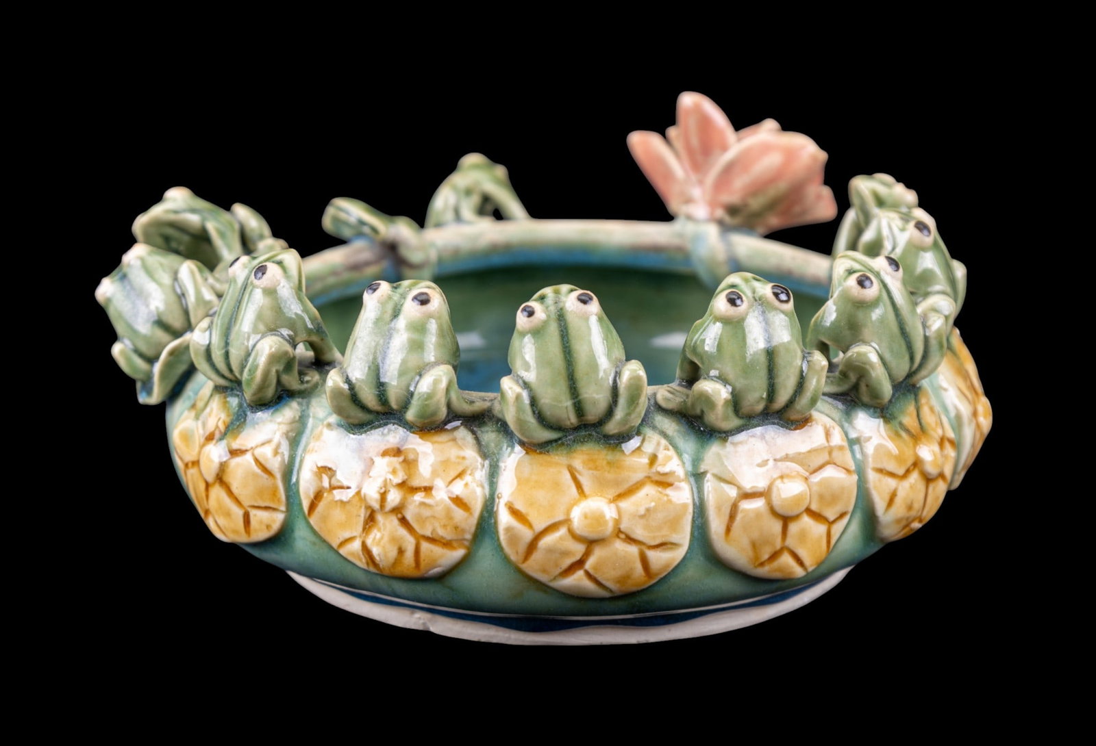 Majolica Pottery Flower Saucer and Murano Frog: Contemporary majolica style pottery flower pot saucer, with figural frogs and lily decorations and high gloss glaze. Measures approx. 3.75" H x 7.75" diam. Also included are a hand blown Murano glass 