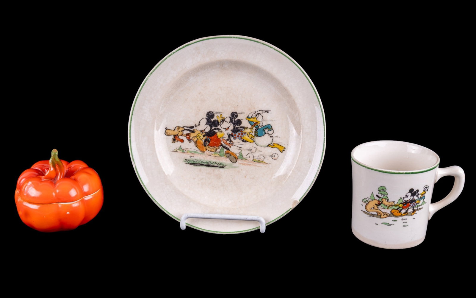 Vintage Disney Mickey Mouse Cup Set and More: A vintage Disney Mickey Mouse mug and saucer set (rim chip on plate), and a painted porcelain figural tomato jar by Royal Bayreuth Bavaria.