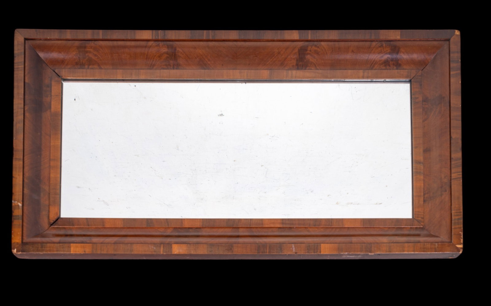 19th C American Empire Style Mirror: A 19th Century American empire style mirror with mahogany veneer. Measures approx. 45.5" H x 22.5" W. Slight loss to veneer as seen in photography.
