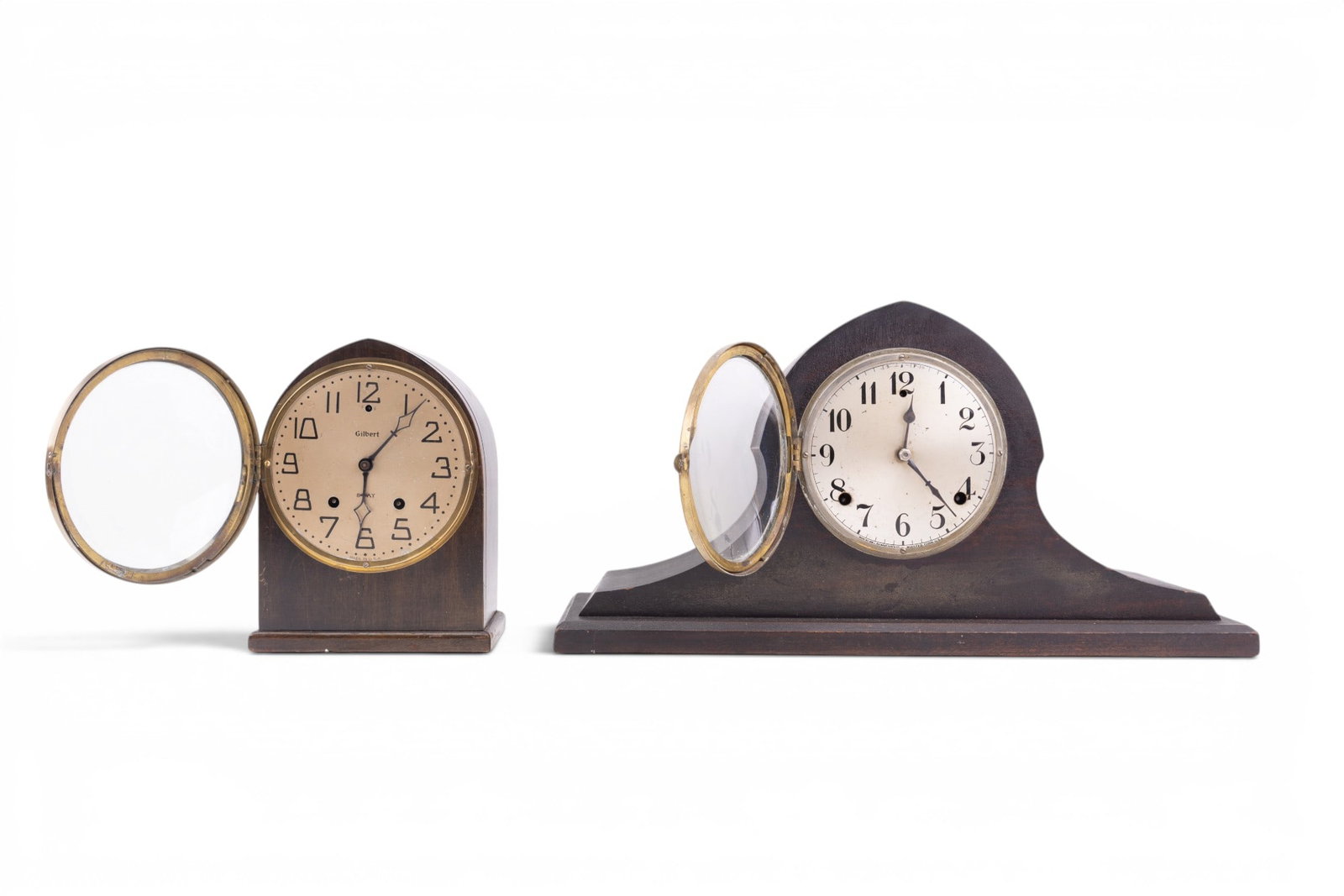 Gilbert Tambour & Cathedral Beehive Mantle Clocks: Early Gilbert mantle clocks featuring a Tambur or Camelback clock, includes pendulum, measures approx. 19" W x 5" D x 10" H, and a Cathedral Beehive mantle clock including pendulum, note back door wil