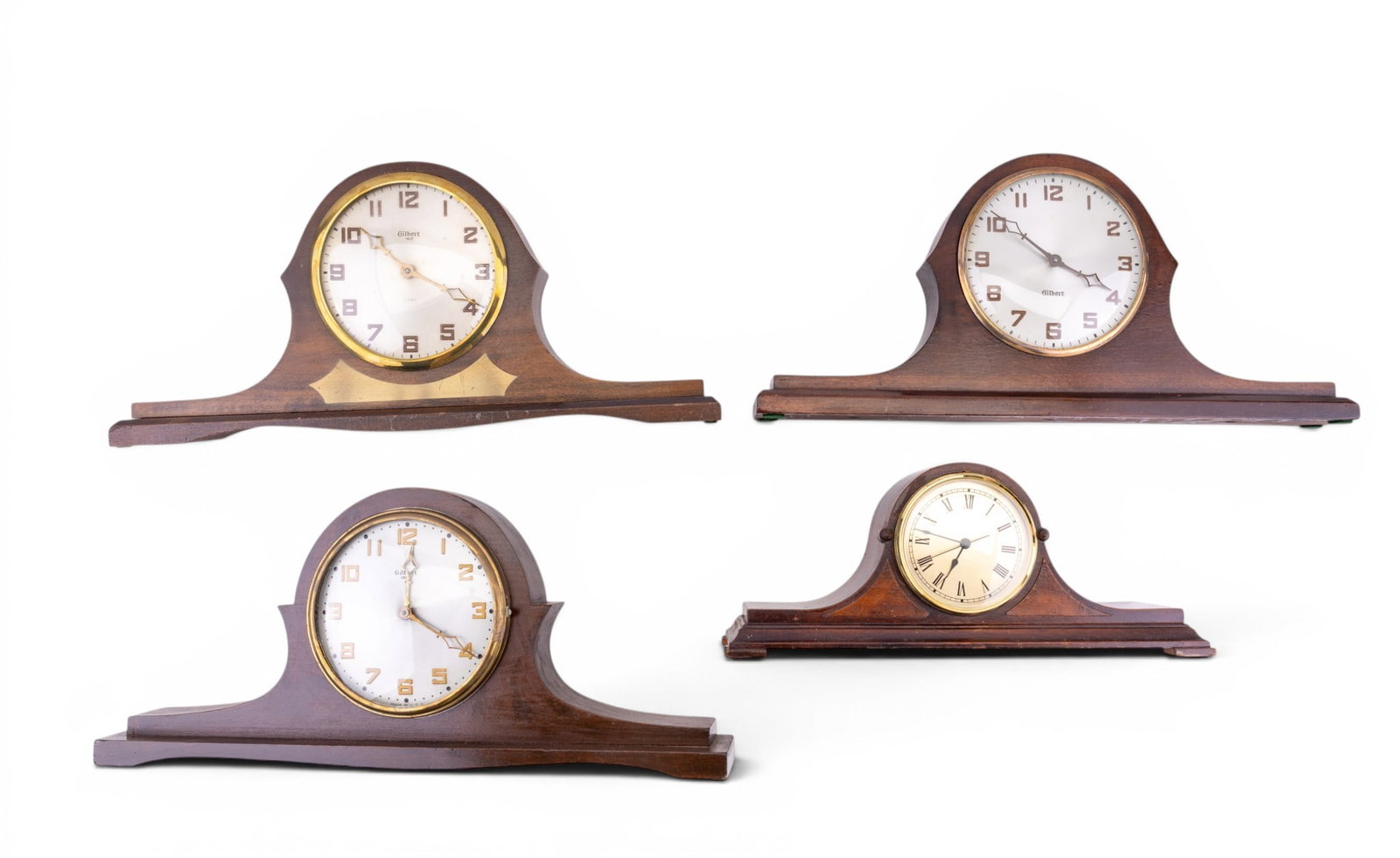 Gilbert Tambour Mantle Clocks: A collection of Gilbert Tambour mantle clocks featuring two wind up, one electric, and an unmarked tambour case with later battery operated movement. Untested, largest measures approx. 18" W x 2.5" D 