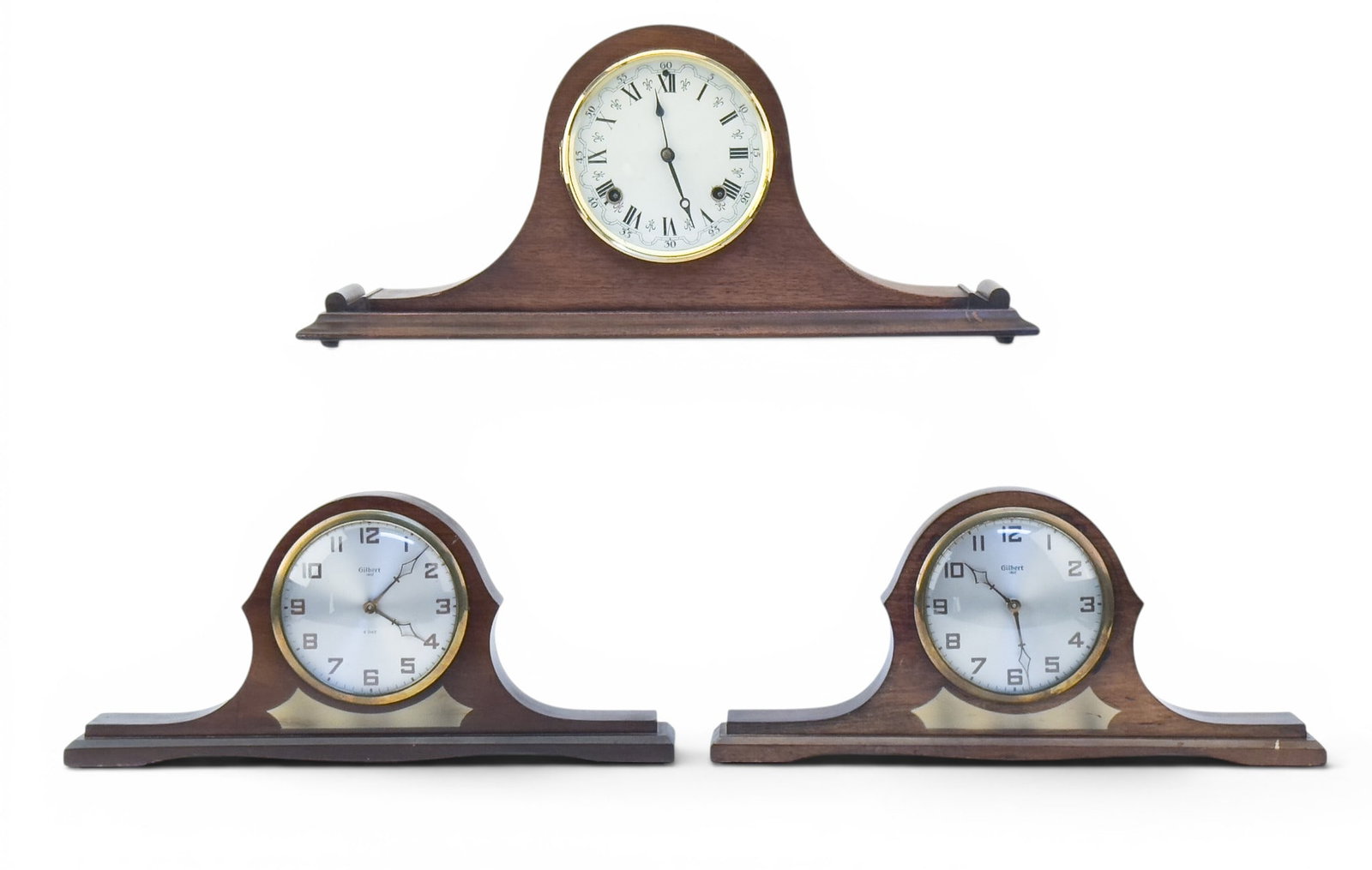 Ingraham and Gilbert Tambour Mantle Clocks: A vintage Ingraham wood case tambour mantle clock, measures approx. 22" W x 5" D x 9.5" H, and two Gilbert tambour wind up mantle clocks, both measure approx. 17.5" W x 3" D x 8" H.