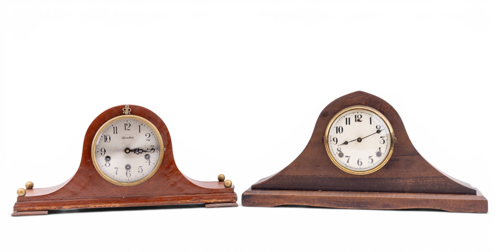 Herschede and Gilbert Mantel Clocks: Lot of 2 mantel clocks including a Herschede mantel clock in arched mahogany-finished case with metal dial and brass movement. Together with a Gilbert mantel clock in wooden case with dial marked "Wil