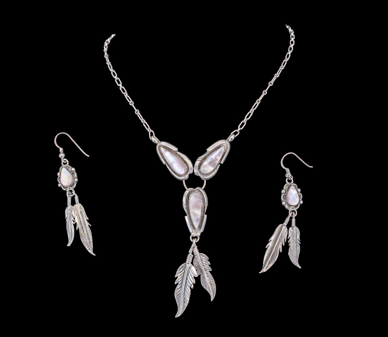 Vintage Native Jewelry: Includes a silver native necklace set with mother of pearl pieces and long silver feather details; also includes a matching pair of pierced earrings.