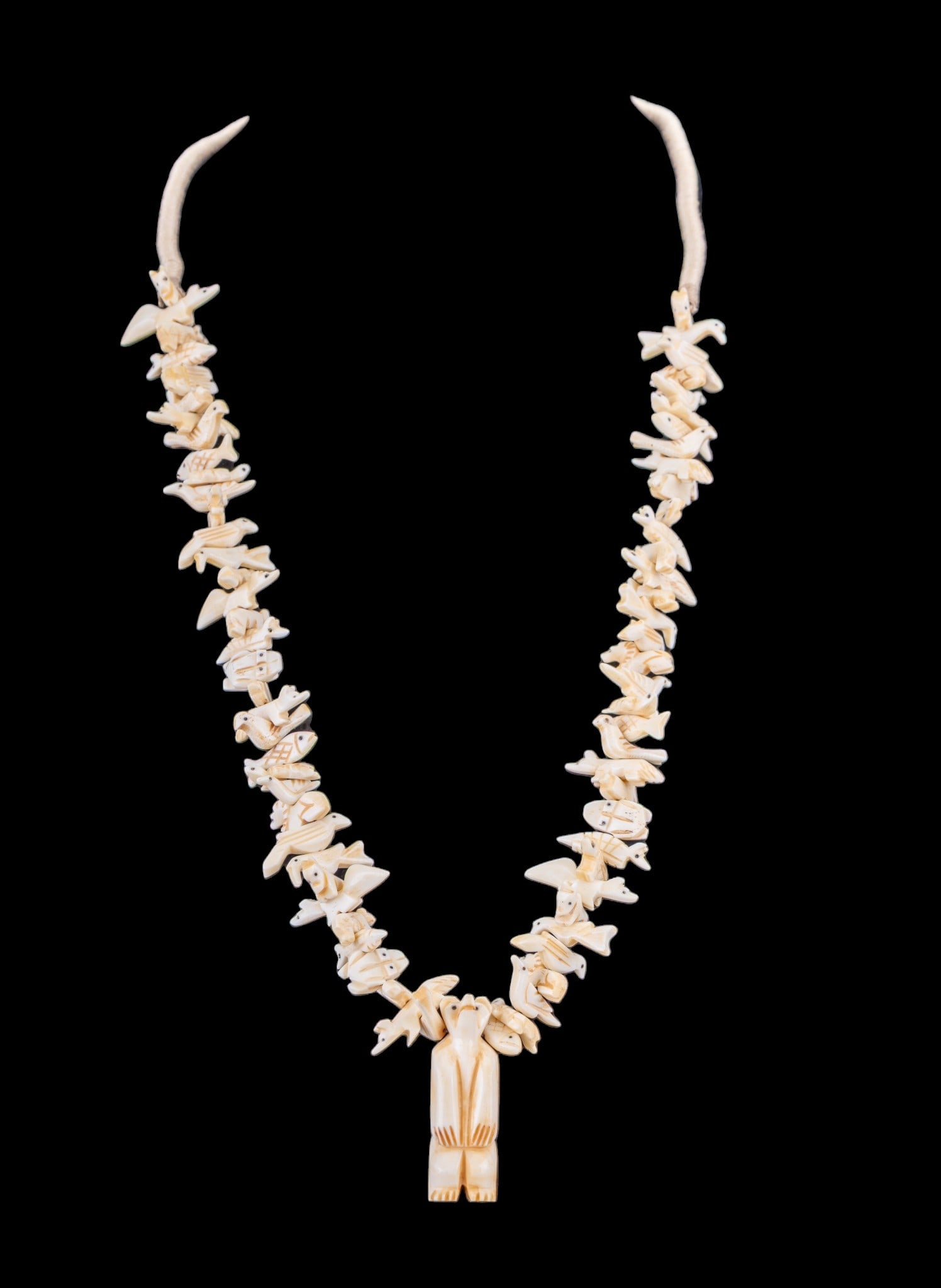 Carved Fetish Necklace: Large natural material carved vintage Native fetish necklace with a carved Bear as the central piece, along with a variety of animals including foxes, fish and a variety of others.
