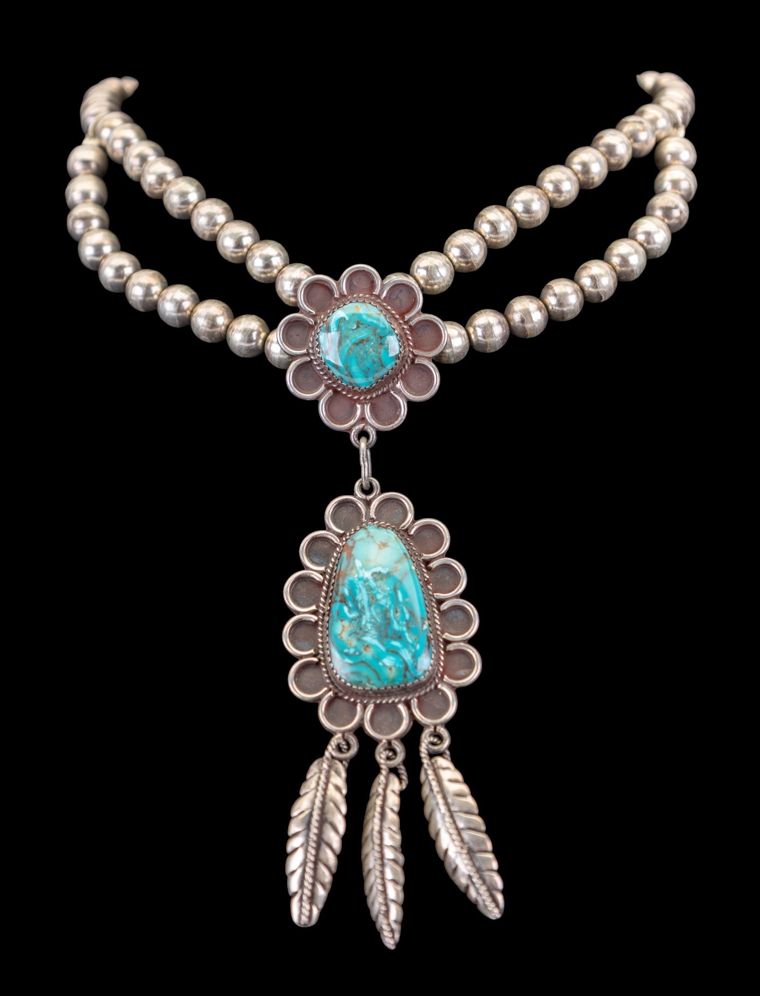 Turquoise Native Necklace: Vintage Native collar or choker style necklace with two large pieces of blue turquoise and silver feather dangle details.